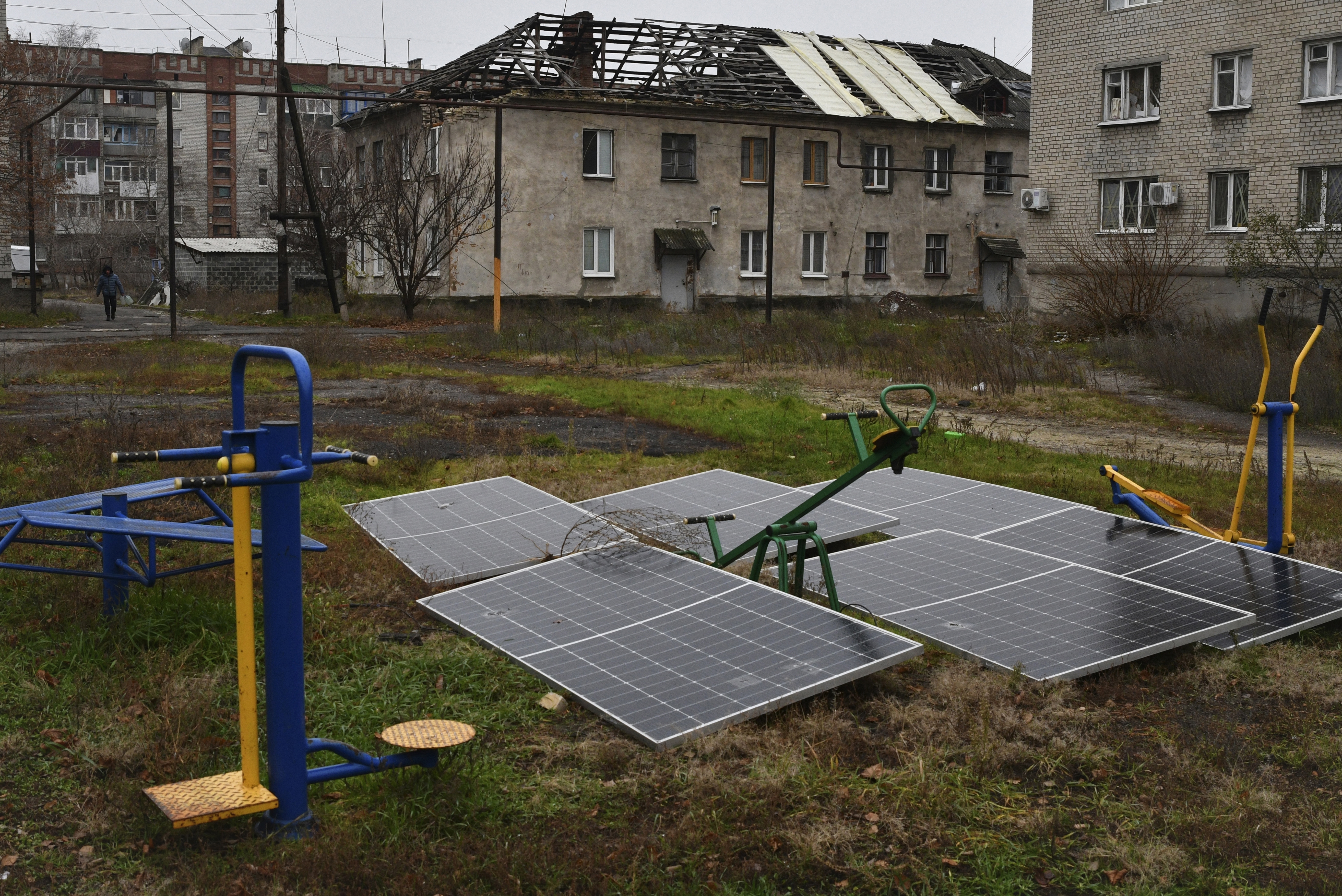 FILE - Solar panels sit in the yard of an apartment building in Lyman, Donetsk region, Ukraine, Nov. 20, 2022. (AP Photo/Andriy Andriyenko, File)