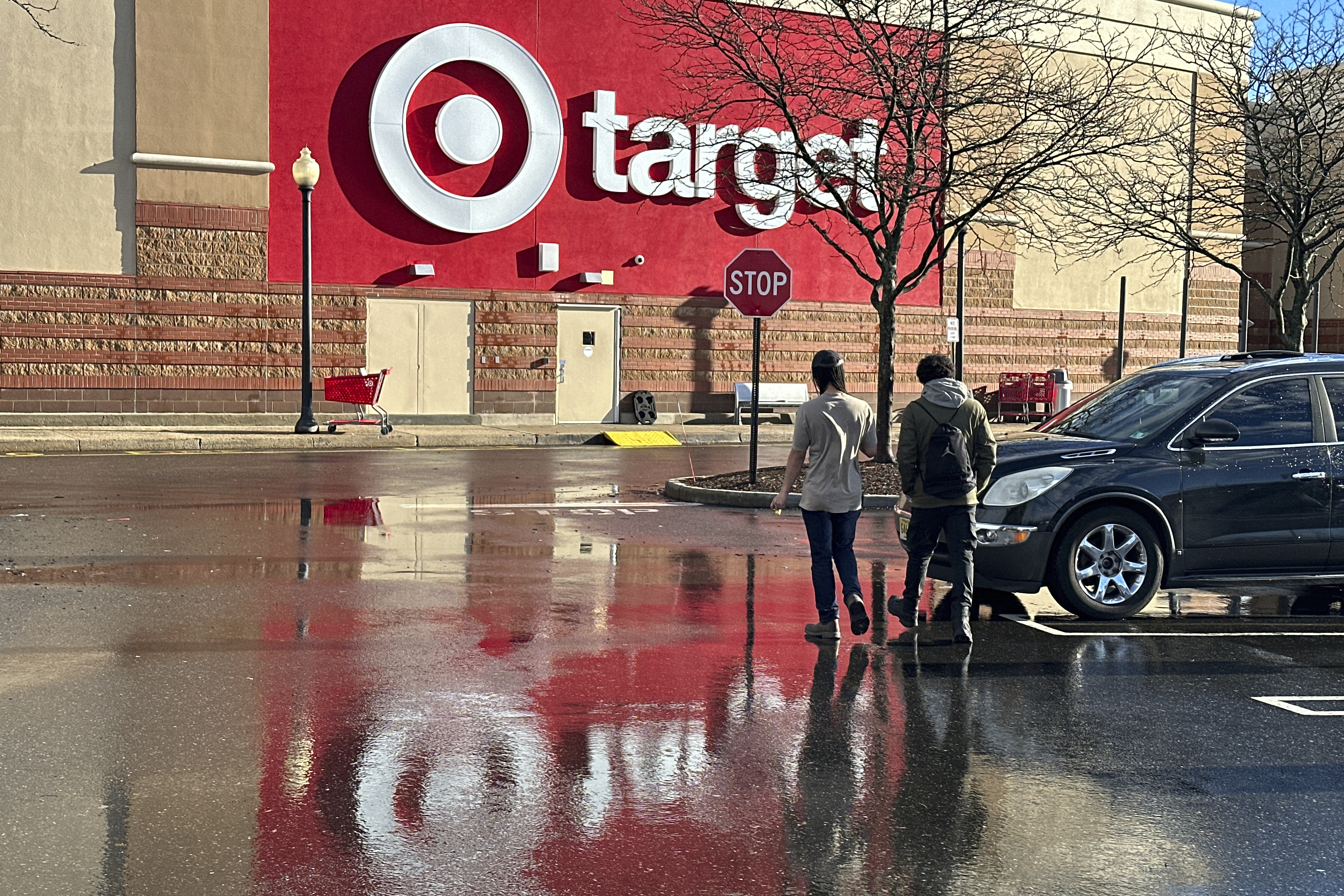 FILE - People walk towards a Target store in Clifton, N.J., on December 18, 2023. (AP Photo/Ted Shaffrey, File)