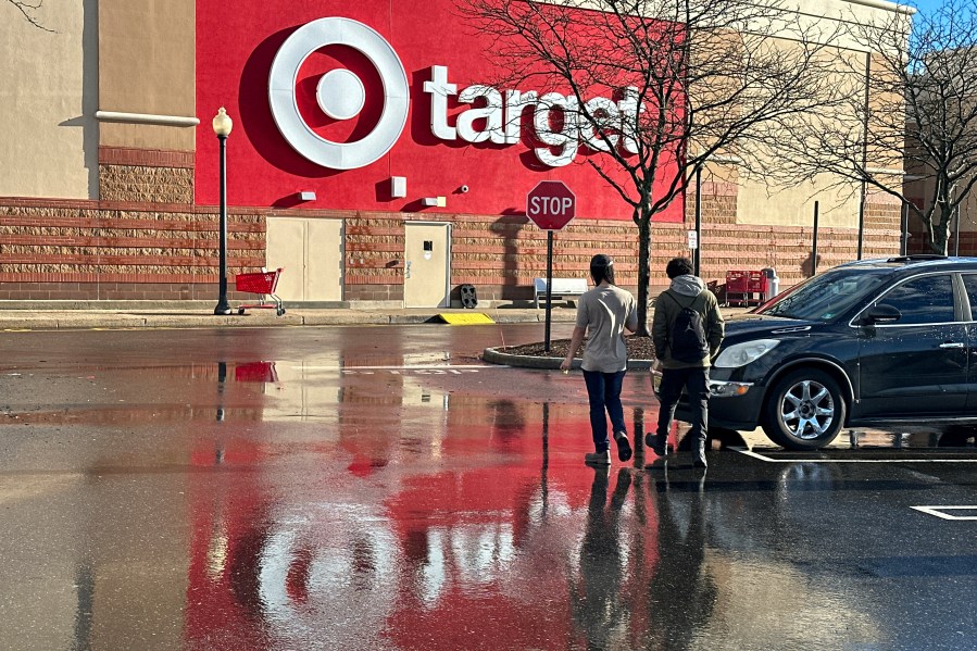 FILE - People walk towards a Target store in Clifton, N.J., on December 18, 2023. (AP Photo/Ted Shaffrey, File)