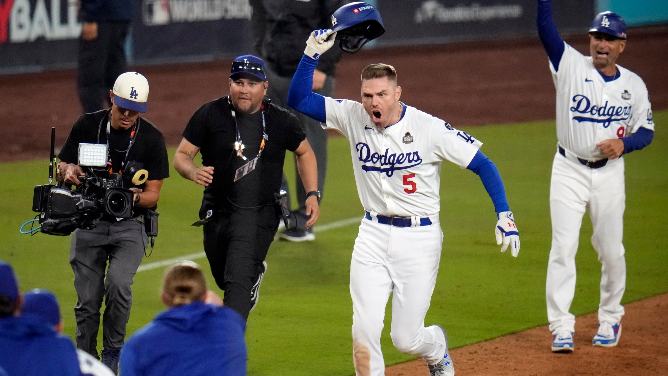 Los Angeles Dodgers' Freddie Freeman (5) celebrates after hitting a game-winning grand slam against the New York Yankees during the 10th inning in Game 1 of the baseball World Series, Friday, Oct. 25, 2024, in Los Angeles. The Dodgers won 6-3. (AP Photo/Julio Cortez)