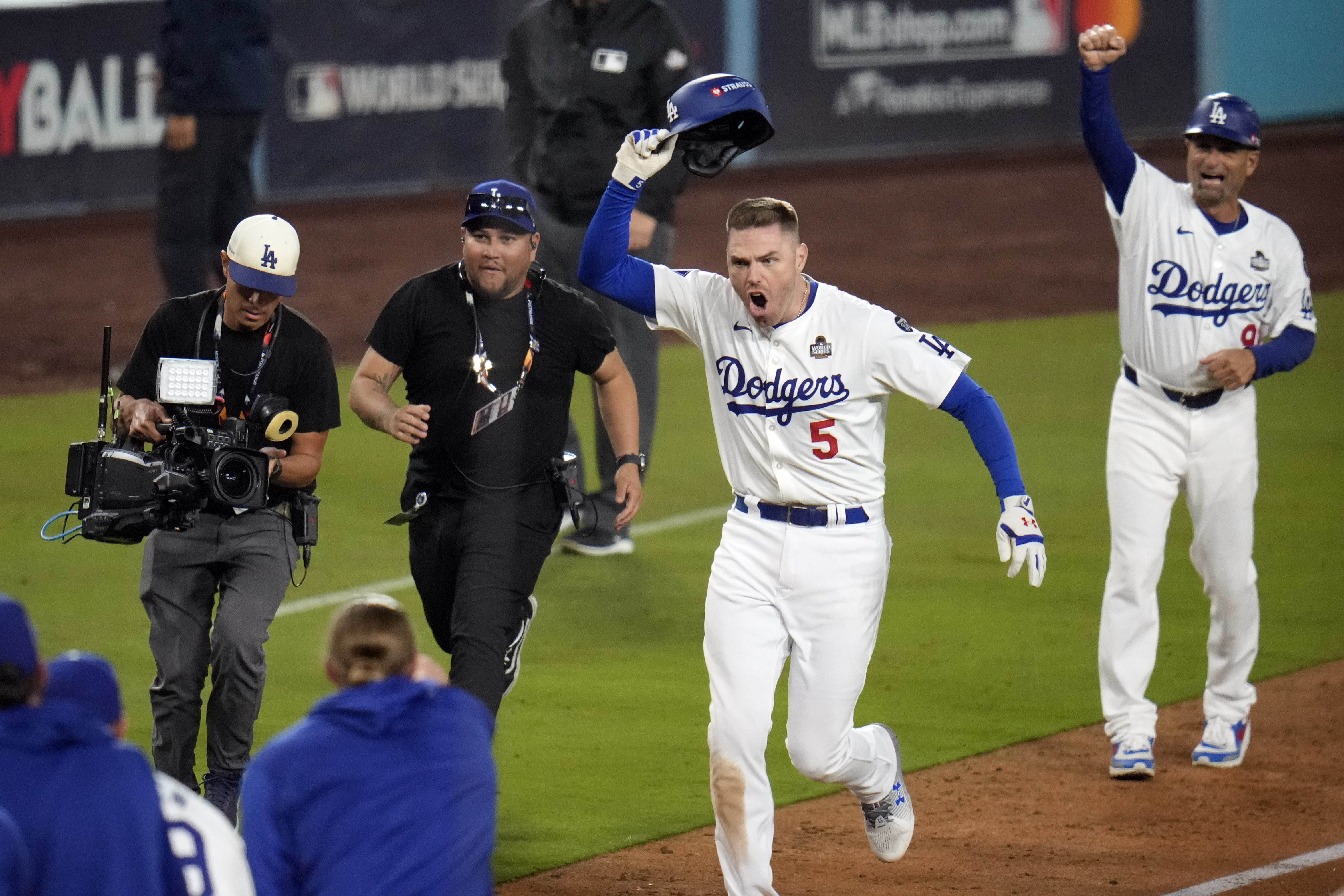 Los Angeles Dodgers' Freddie Freeman (5) celebrates after hitting a game-winning grand slam against the New York Yankees during the 10th inning in Game 1 of the baseball World Series, Friday, Oct. 25, 2024, in Los Angeles. The Dodgers won 6-3. (AP Photo/Julio Cortez)