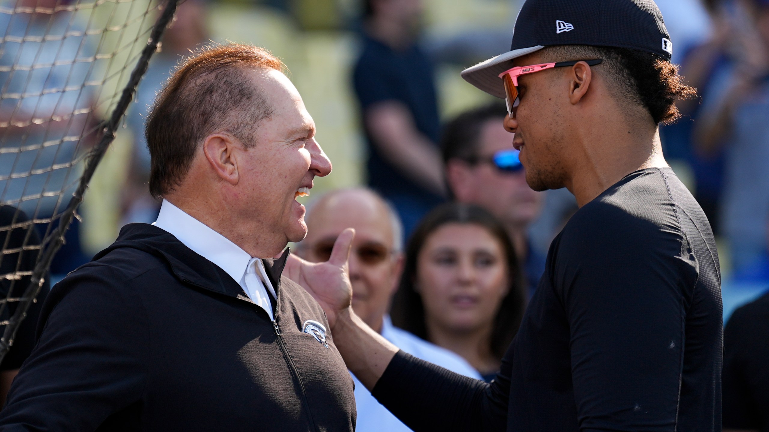 New York Yankees' Juan Soto talks with agent Scott Boras before Game 1 of the baseball World Series against the Los Angeles Dodgers, Friday, Oct. 25, 2024, in Los Angeles. (AP Photo/Julio Cortez)