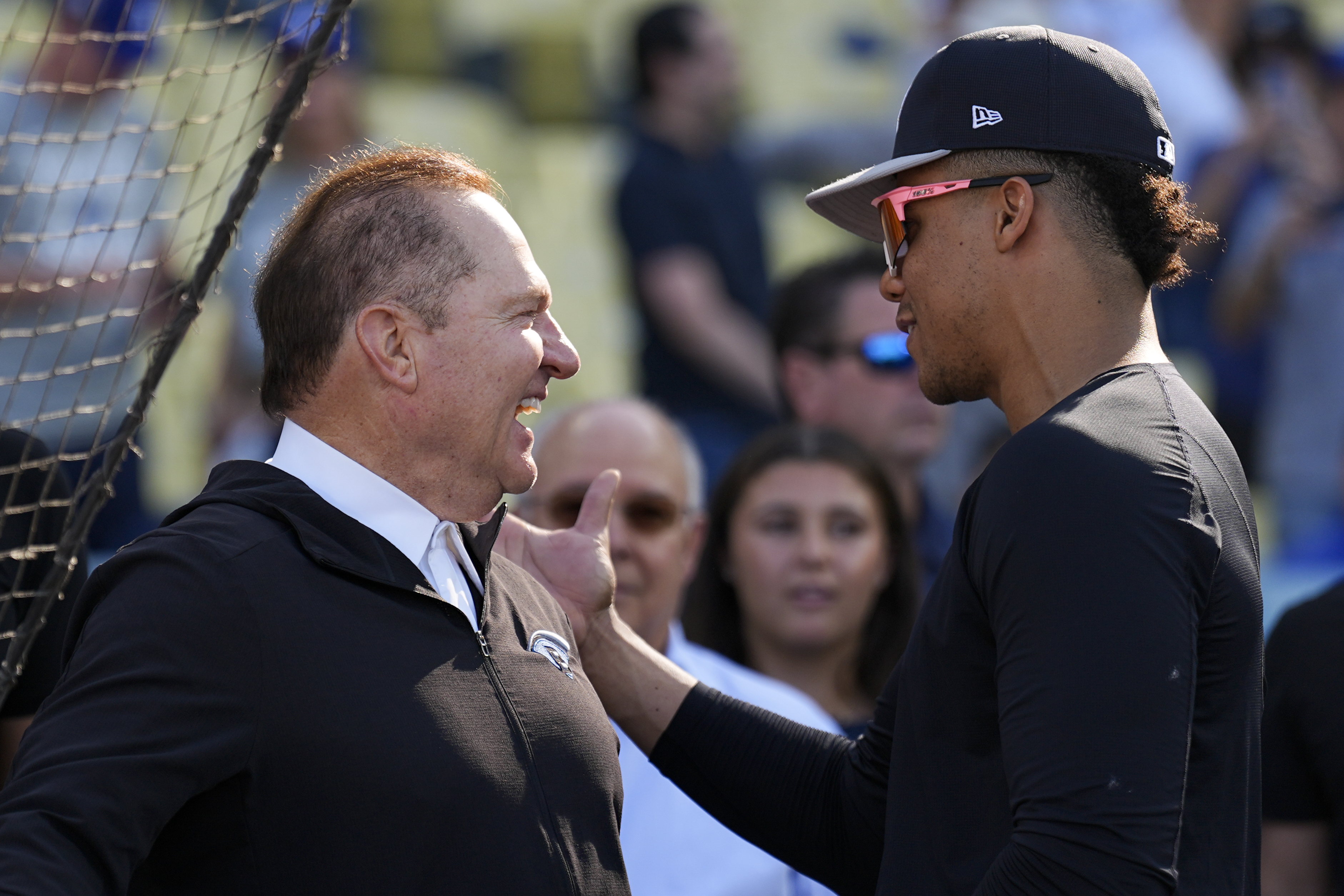 New York Yankees' Juan Soto talks with agent Scott Boras before Game 1 of the baseball World Series against the Los Angeles Dodgers, Friday, Oct. 25, 2024, in Los Angeles. (AP Photo/Julio Cortez)