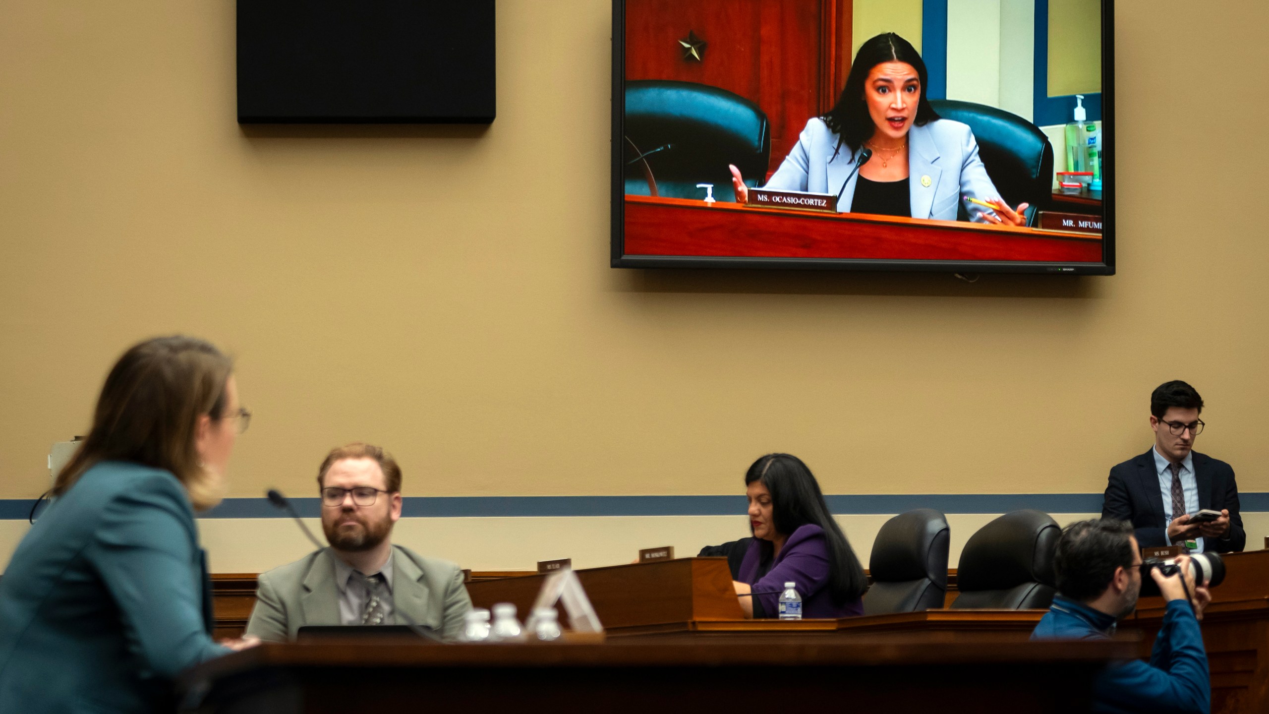 Rep. Alexandria Ocasio-Cortez, D-N.Y., seen on video screen, addresses Administrator of the Federal Emergency Management Agency (FEMA) Deanne Criswell, left, as she testifies in front a House Committee on Oversight and Accountability hearing on oversight of FEMA, on Capitol Hill in Washington, Tuesday, Nov. 19, 2024. (AP Photo/Ben Curtis)