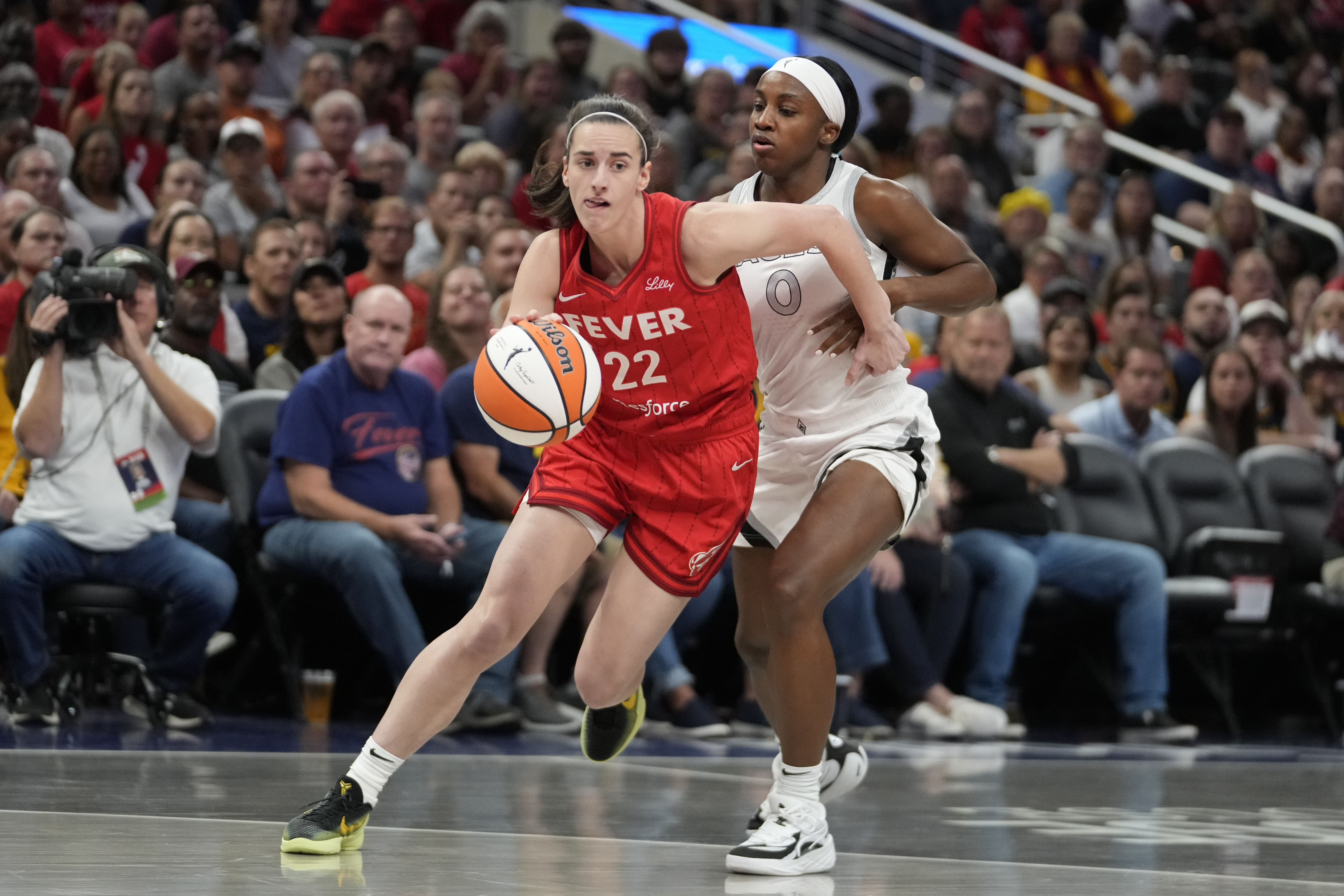 FILE - Indiana Fever's Caitlin Clark (22) goes to the basket against Las Vegas Aces' Jackie Young (0) during the first half of a WNBA basketball game, Sept. 11, 2024, in Indianapolis. (AP Photo/Darron Cummings, File)