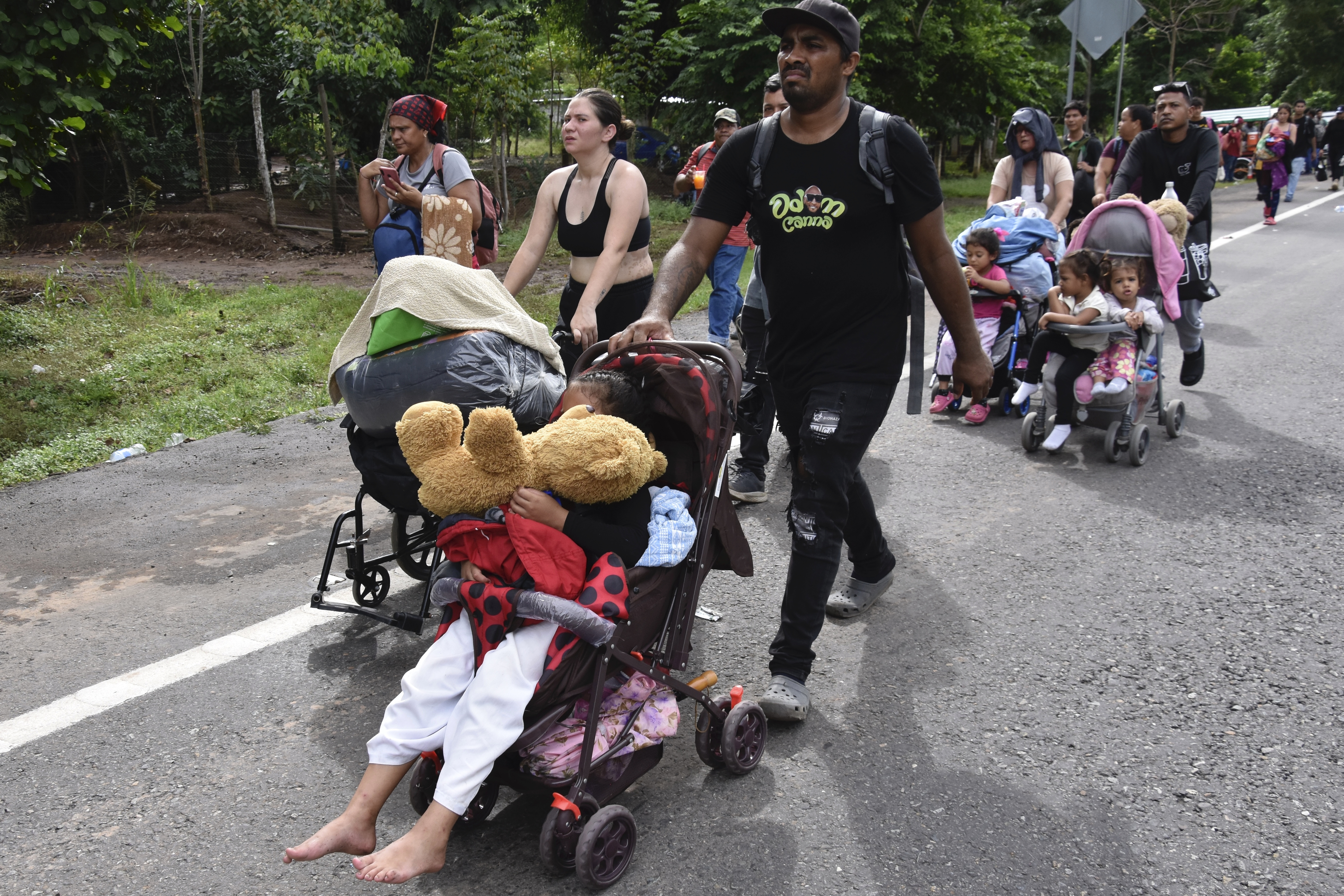 Migrants walk through Tapachula, Chiapas state, Mexico, Wednesday, Nov. 20, 2024, hoping to reach the U.S. border. (AP Photo/Edgar H. Clemente)