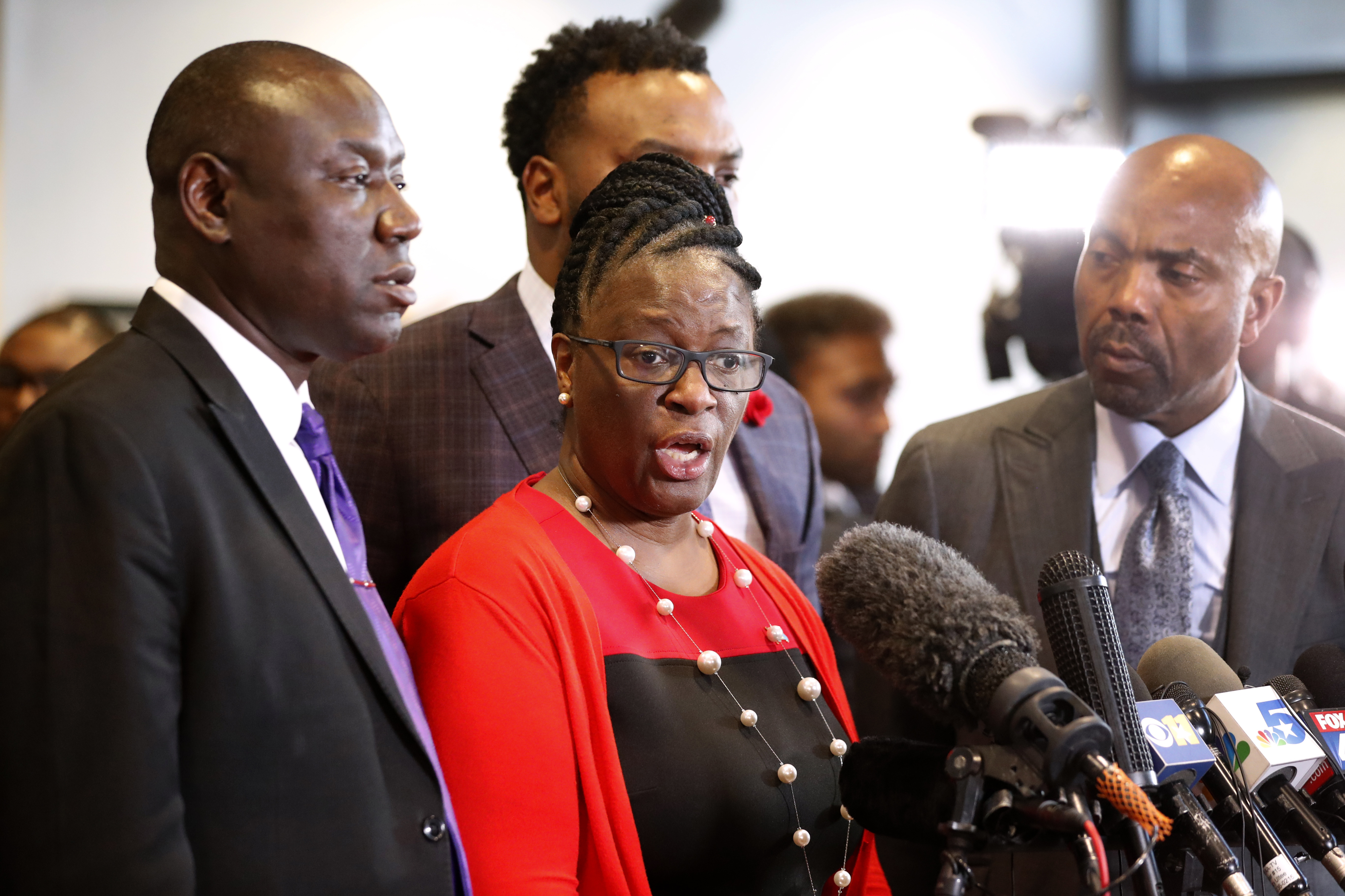 FILE - Allison Jean, center, mother of Botham Jean, makes comments during a news conference as attorneys Ben Crump, left, Lee Merritt, rear, and Daryl Washington, right, look on after the sentencing phase of former Dallas police officer Amber Guyger's murder trial at Frank Crowley Court Building in Dallas, Oct. 2, 2019. (AP Photo/Tony Gutierrez, File)