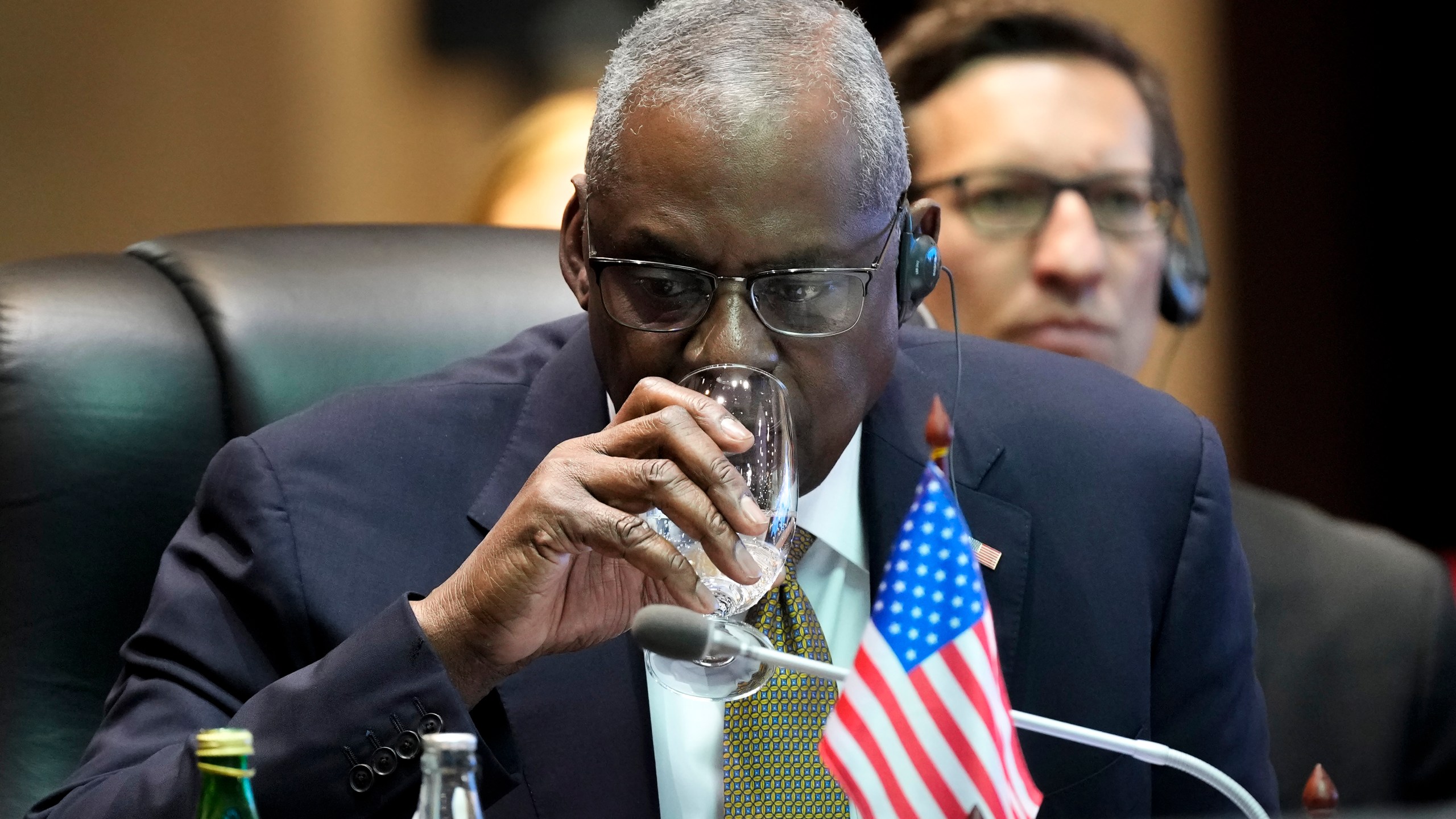 US Defense Secretary Lloyd Austin drinks water during the Association of Southeast Asian Nations (ASEAN) defense ministers' meeting in Vientiane, Laos, Thursday, Nov. 21, 2024. (AP Photo/Anupam Nath)