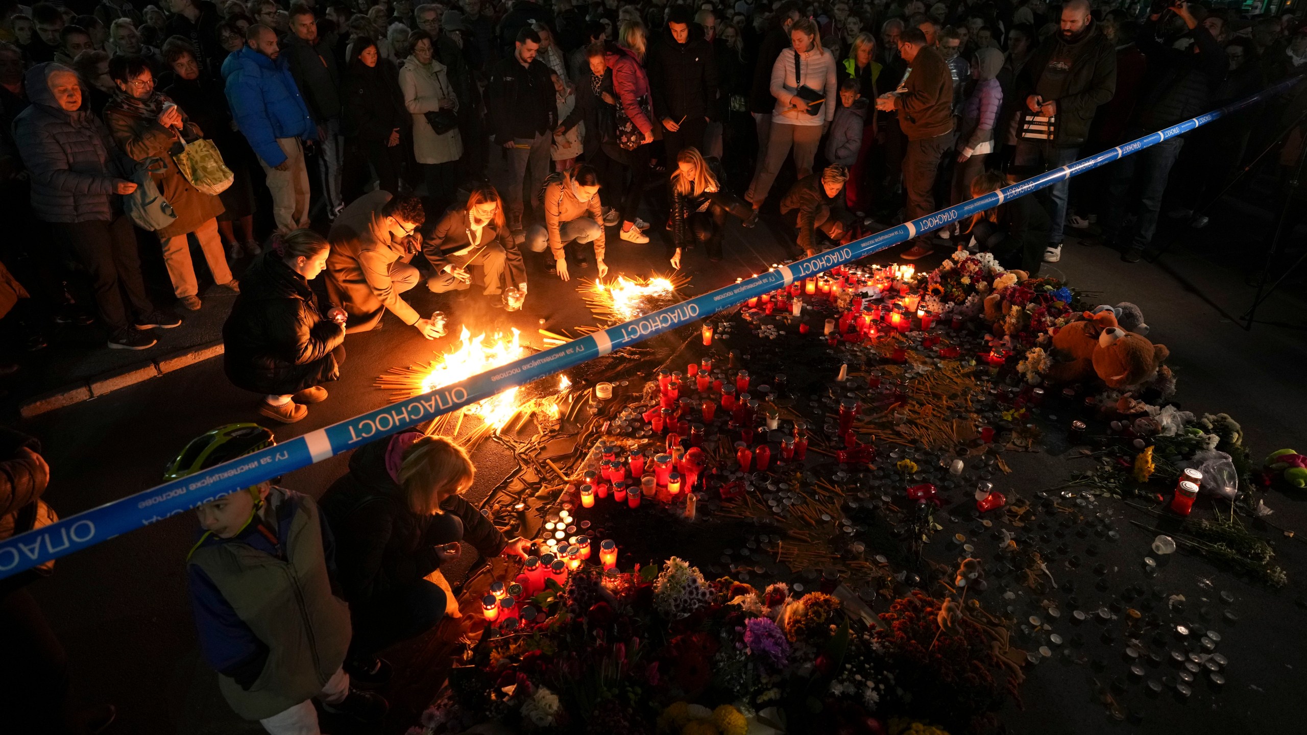 People light candles for the victims after an outdoor roof collapsed at a train station in Novi Sad, Serbia, Saturday, Nov. 2, 2024. (AP Photo/Darko Vojinovic)