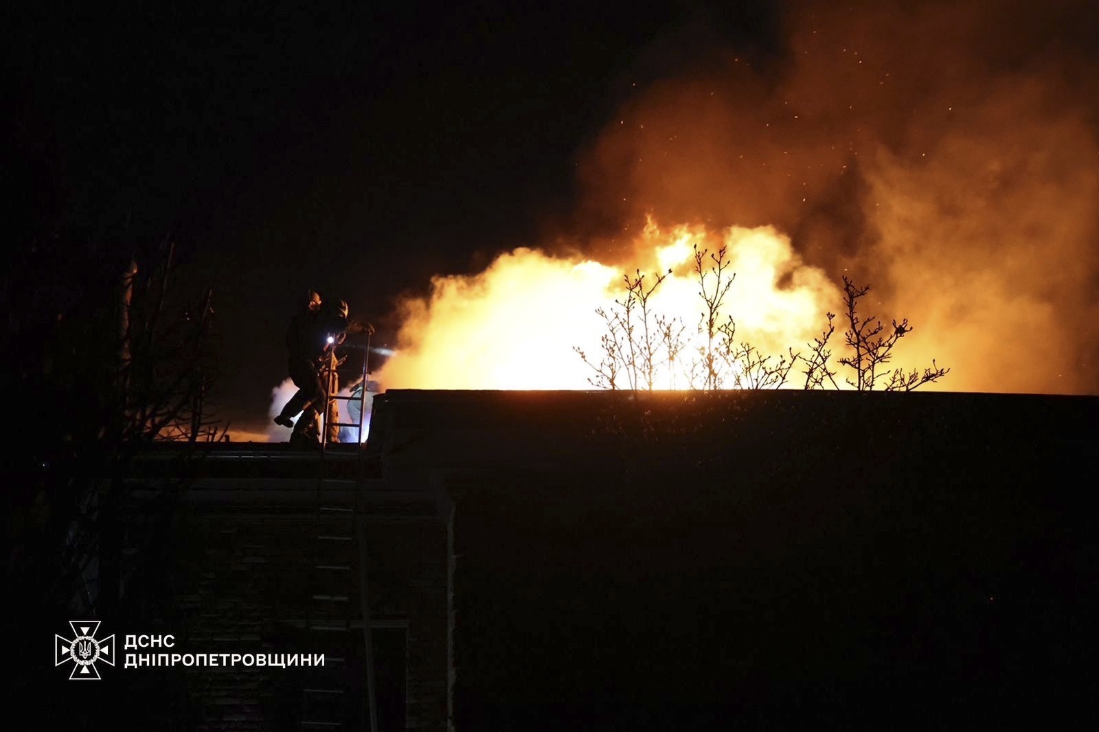 In this photo provided by the Ukrainian Emergency Services on Nov. 21, 2024, rescue workers put out a fire of a building which was heavily damaged by a Russian strike on Dnipro, Ukraine. (Ukrainian Emergency Service via AP)