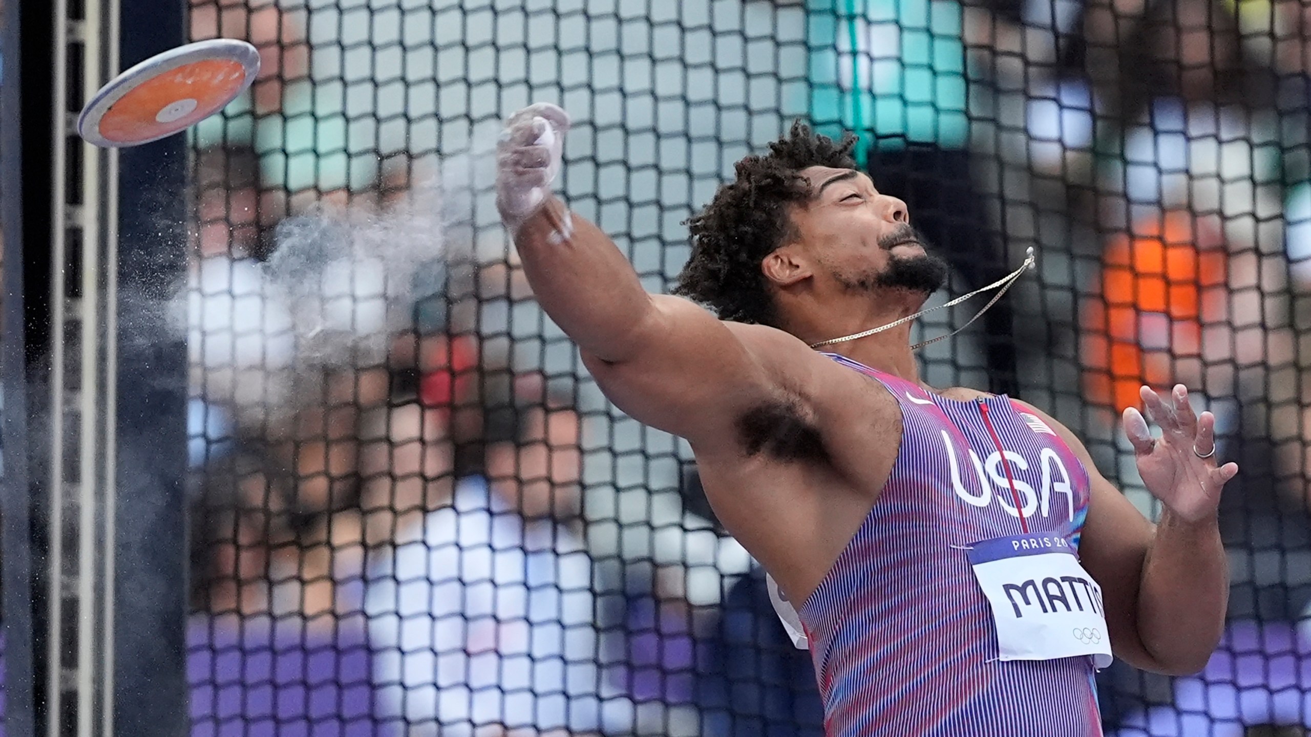 FILE - Sam Mattis, of the United States, competes during the men's discus throw qualification at the 2024 Summer Olympics, Aug. 5, 2024, in Saint-Denis, France. (AP Photo/Matthias Schrader, File)