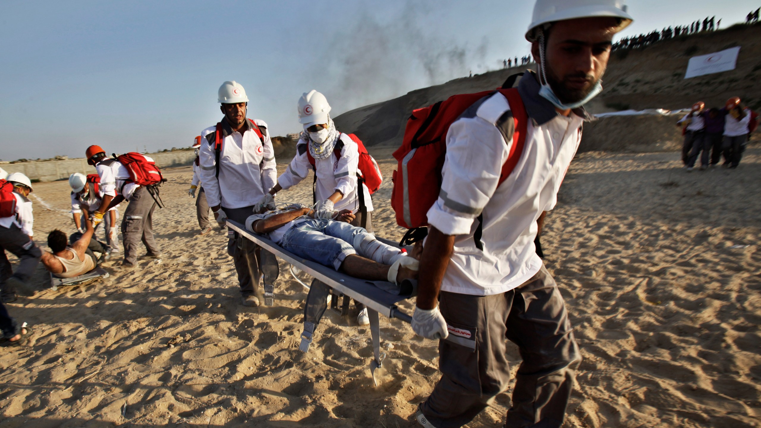 FILE- Medics from the Palestine Red Crescent Society and volunteers at the National Disaster Response Team "NDRT" , participated in a drill during a graduation ceremony of medics, in Mughraqa, central Gaza Strip, Sept. 5, 2013. (AP Photo/Adel Hana), File)