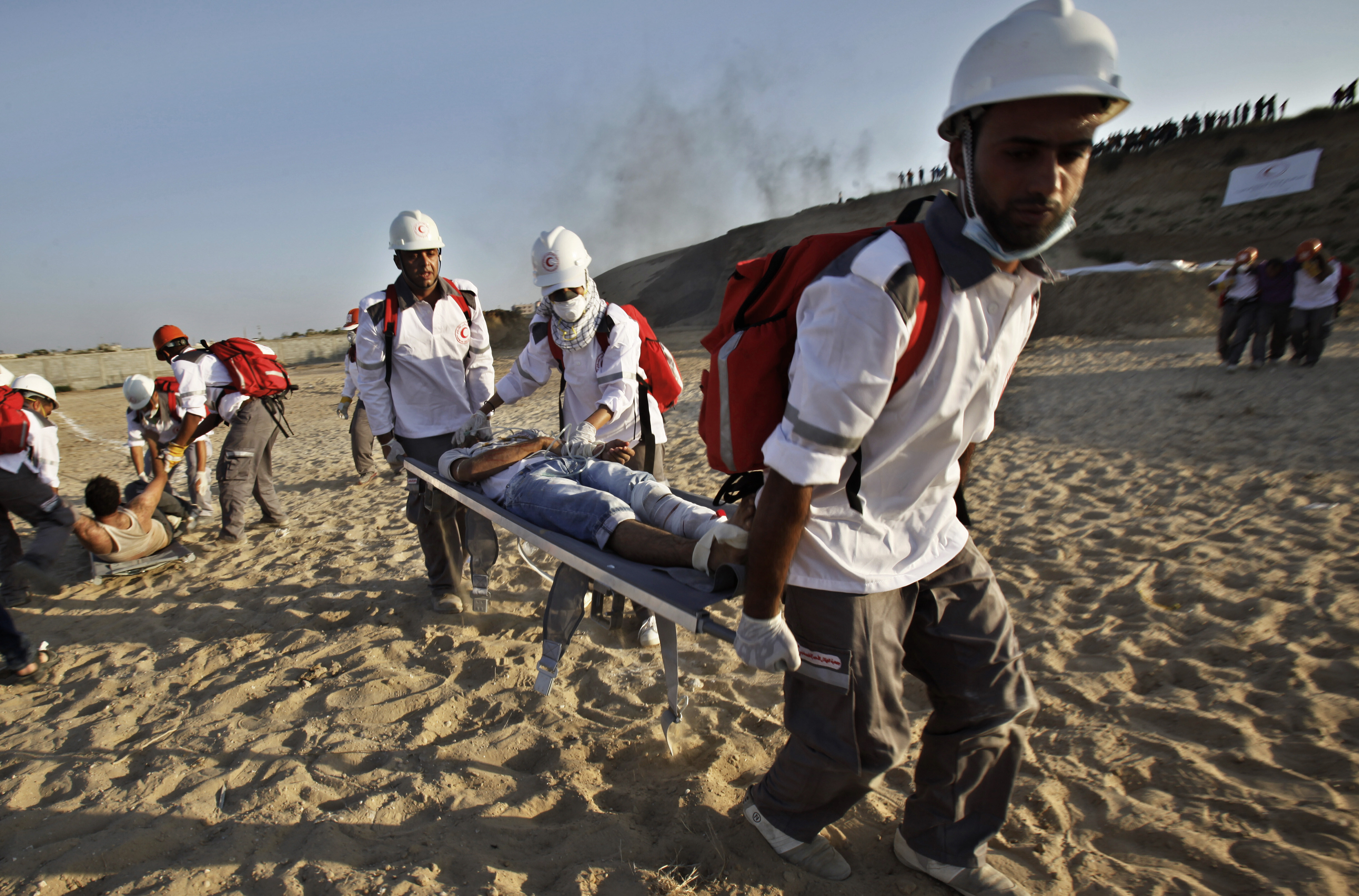 FILE- Medics from the Palestine Red Crescent Society and volunteers at the National Disaster Response Team "NDRT" , participated in a drill during a graduation ceremony of medics, in Mughraqa, central Gaza Strip, Sept. 5, 2013. (AP Photo/Adel Hana), File)