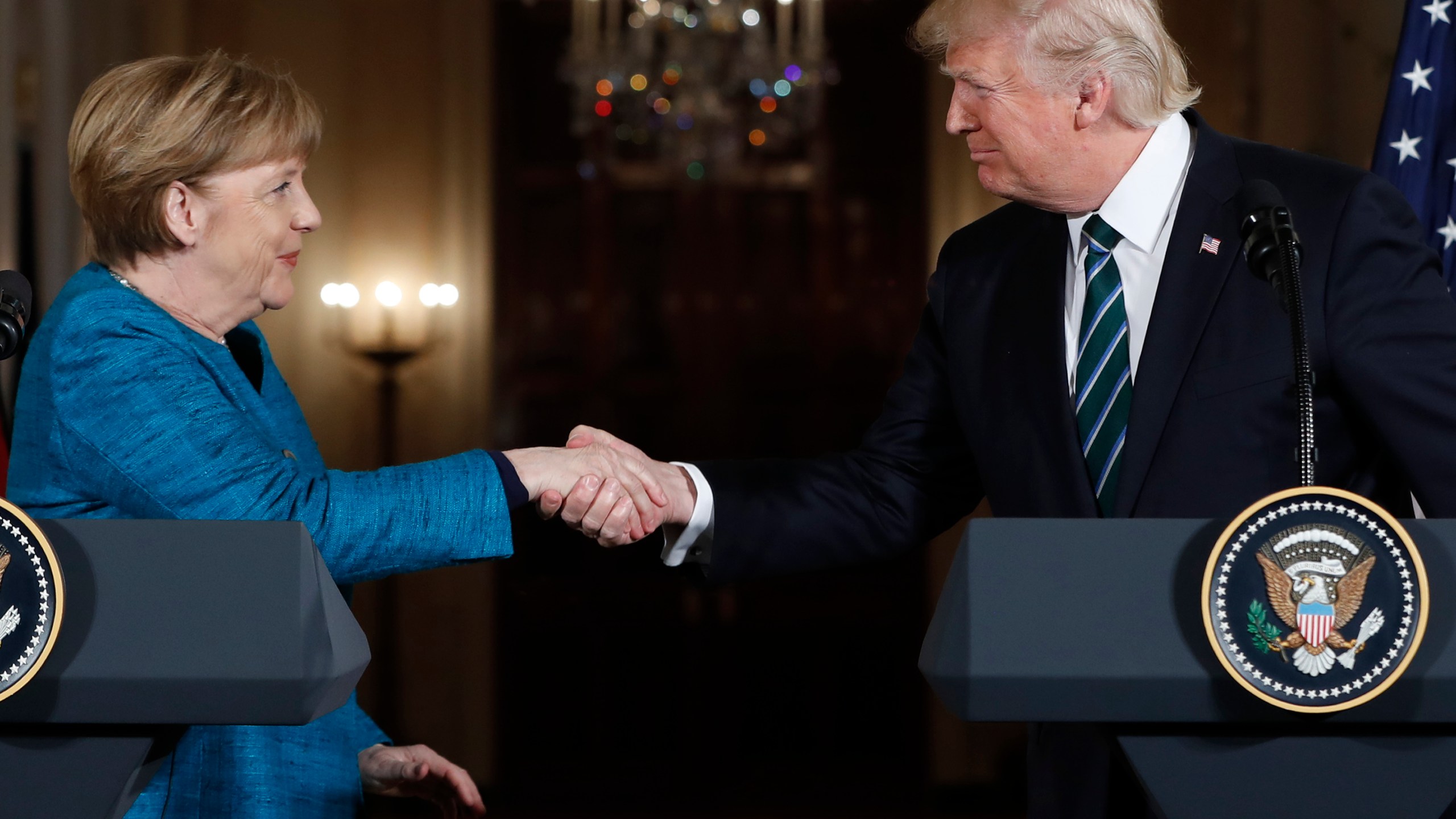 FILE - President Donald Trump and German Chancellor Angela Merkel shake hands following their joint news conference in the East Room of the White House in Washington, Friday, March 17, 2017. (AP Photo/Pablo Martinez Monsivais, File)