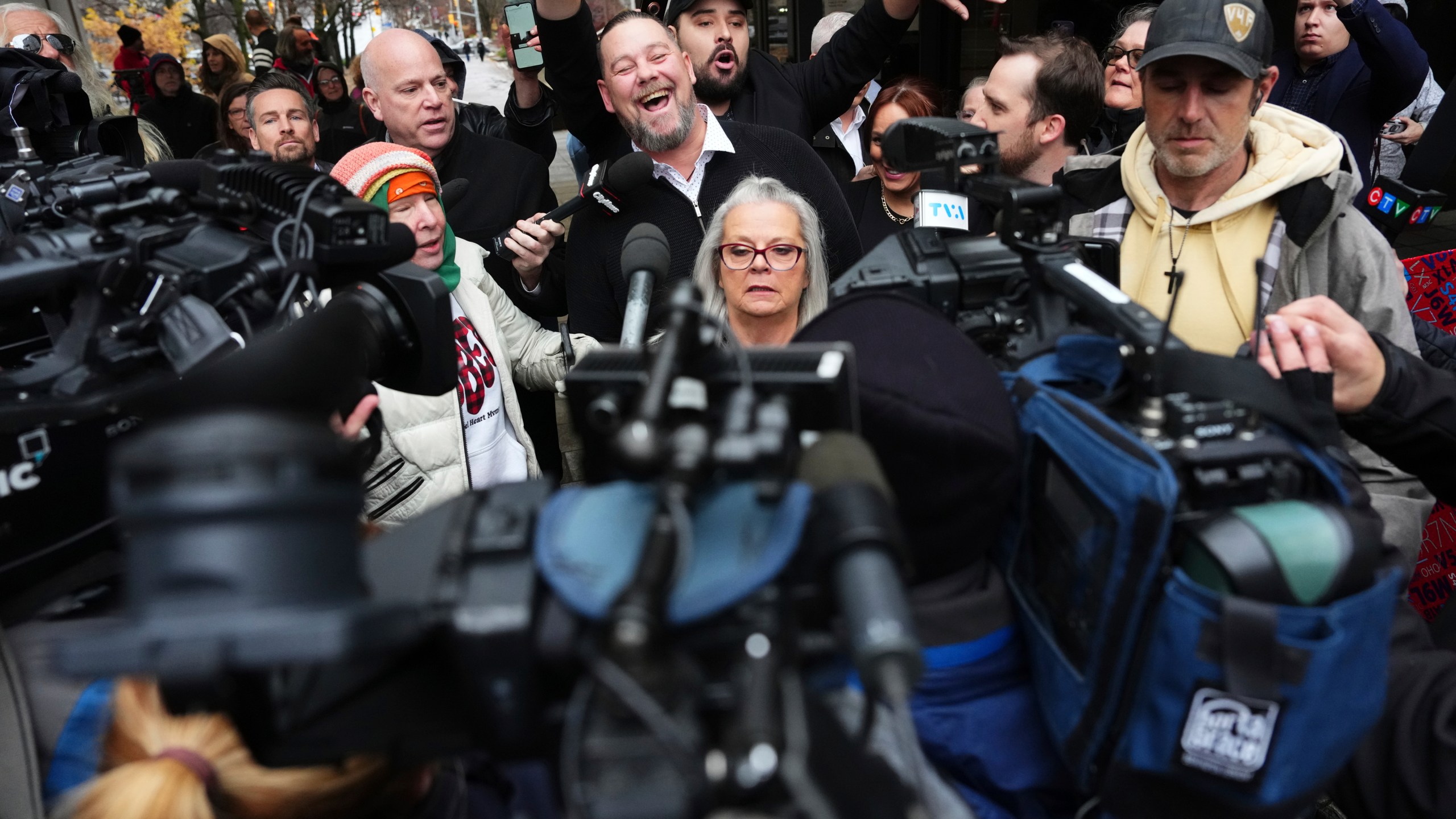 Pat King, top center, a prominent figure in Canada’s trucker protests against COVID-19 restrictions in 2022, is surrounded by supporters and media as he leaves court in Ottawa, Ontario, Friday, Nov. 22, 2024. (Sean Kilpatrick/The Canadian Press via AP)