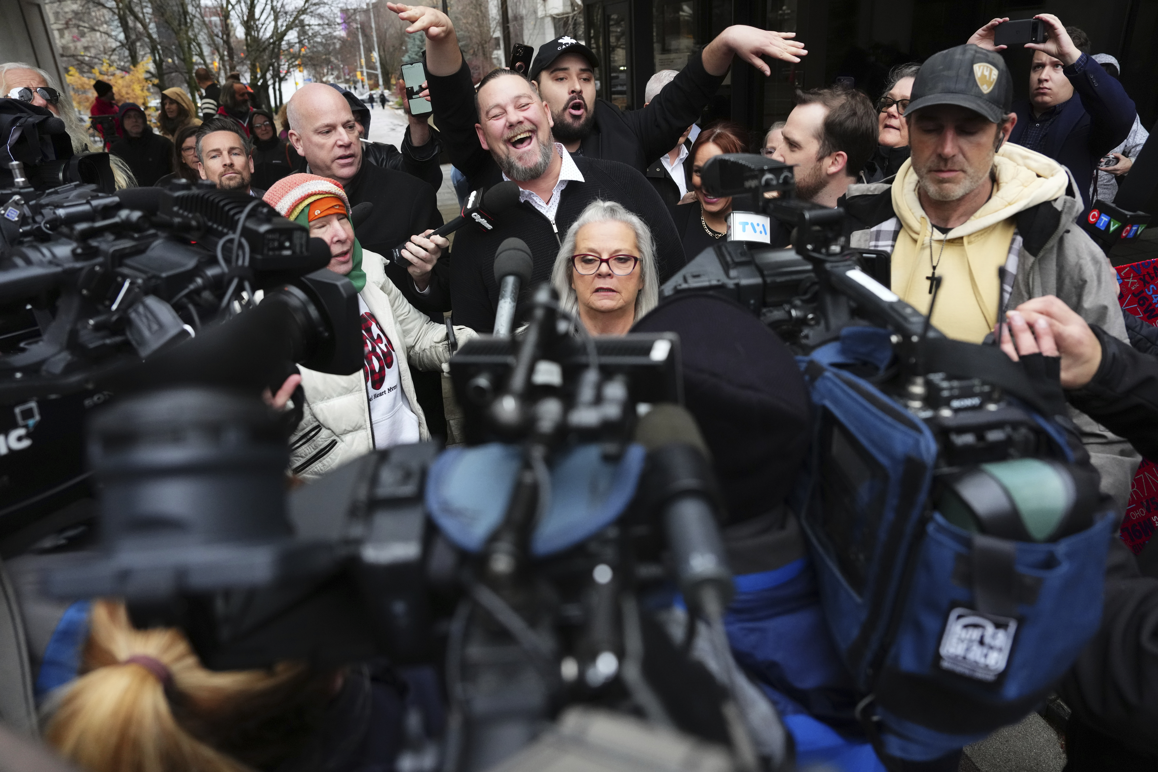 Pat King, top center, a prominent figure in Canada’s trucker protests against COVID-19 restrictions in 2022, is surrounded by supporters and media as he leaves court in Ottawa, Ontario, Friday, Nov. 22, 2024. (Sean Kilpatrick/The Canadian Press via AP)