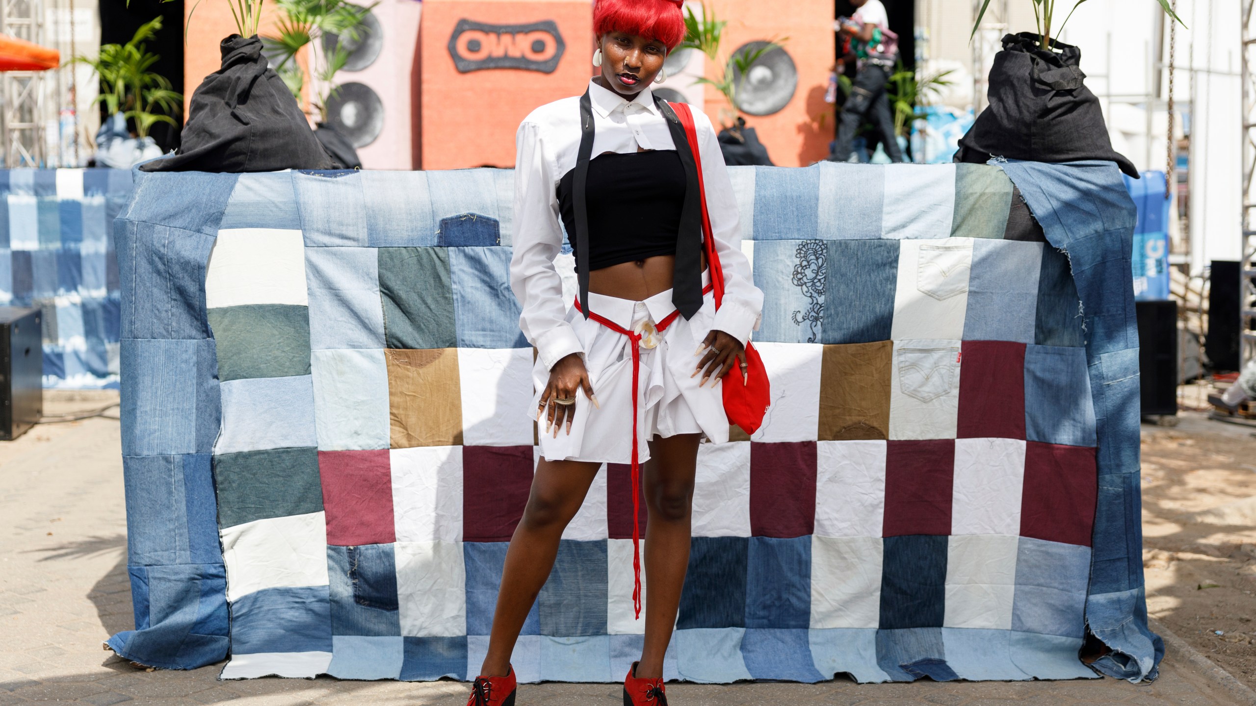 A lady poses for a photograph during a thrift and an upcycle show in Accra, Ghana, Sunday, Oct. 27, 2024. (AP Photo/Misper Apawu)