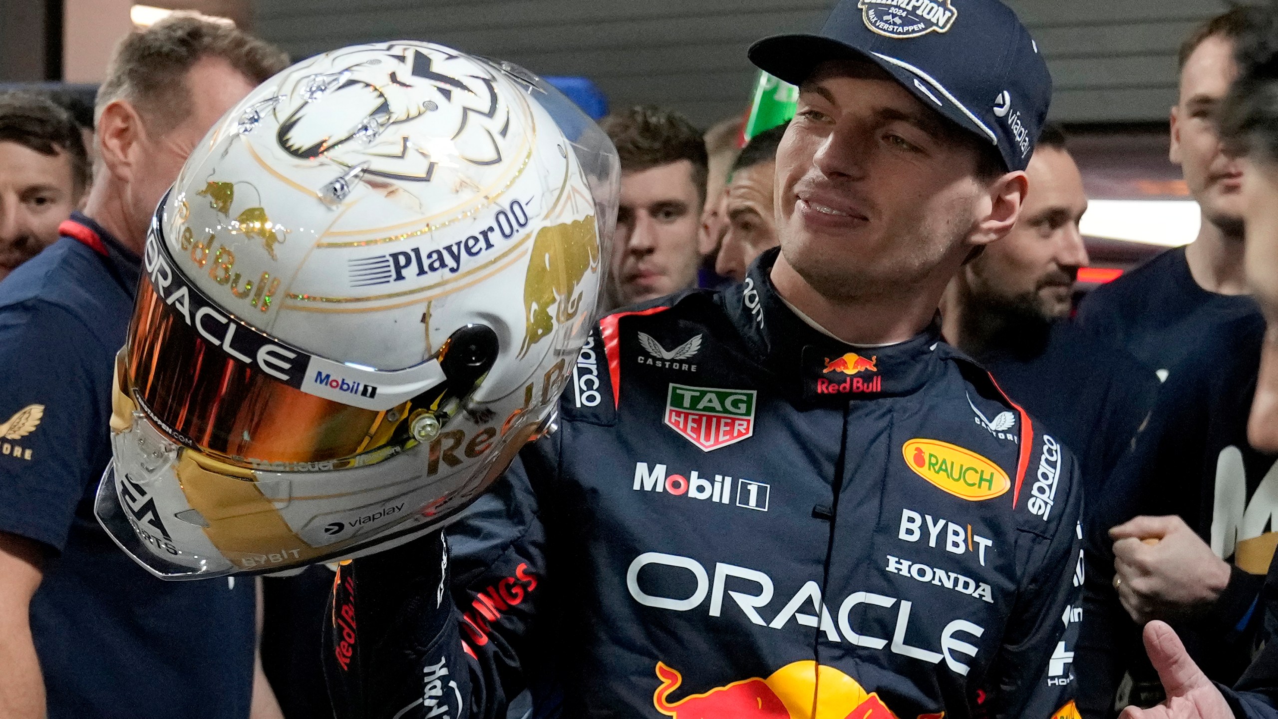 Red Bull driver Max Verstappen, of the Netherlands, looks at a helmet given to him by his team after winning the Formula 1 championship with his team after the F1 Las Vegas Grand Prix auto race, Sunday, Nov. 24, 2024, in Las Vegas. (AP Photo/Matt York)