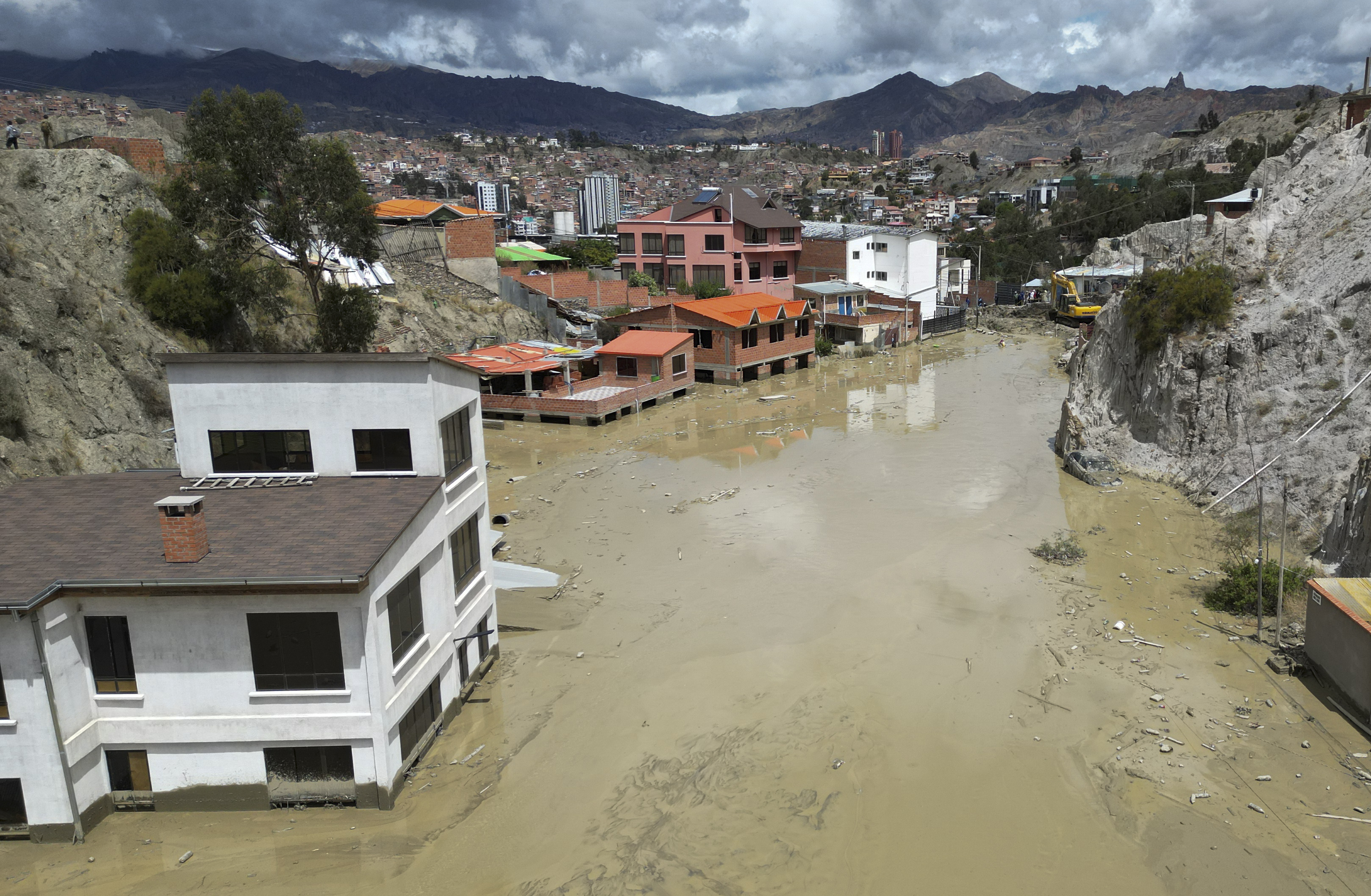 Homes are flooded by the overflowing Pasajahuira River in La Paz, Bolivia, Sunday, Nov. 24, 2024. (AP Photo/Juan Karita)