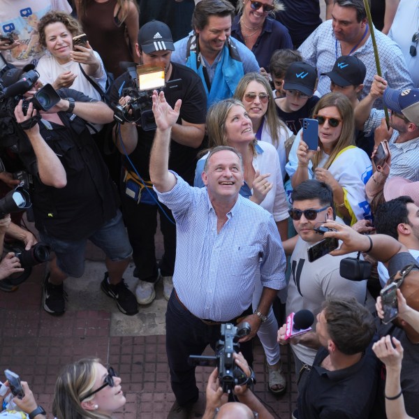 Alvaro Delgado, candidate for the ruling National Party, waves after voting in the presidential run-off election in Montevideo, Uruguay, Sunday, Nov. 24, 2024. (AP Photo/Natacha Pisarenko)