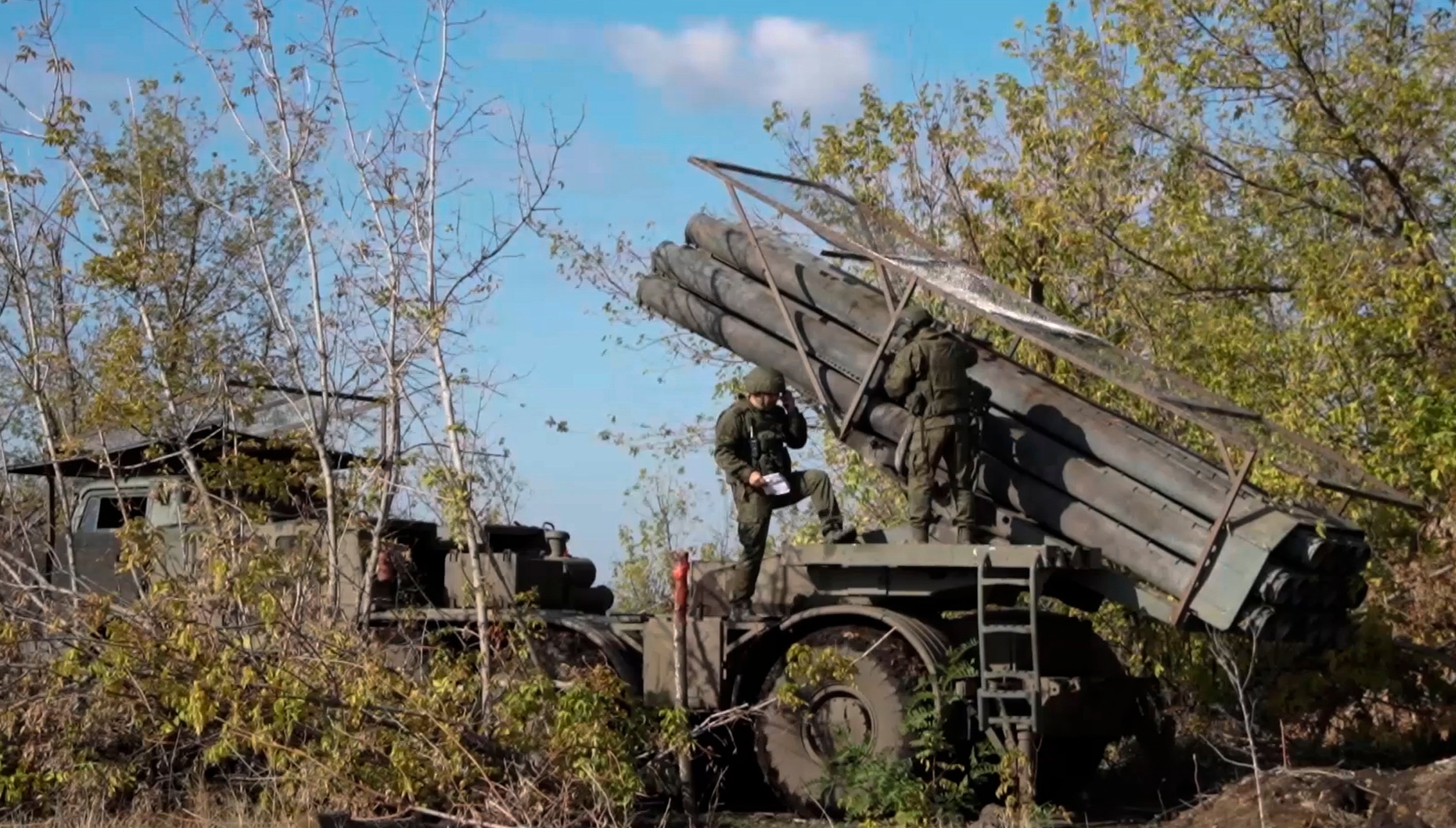 In this photo taken from a video released by Russian Defense Ministry press service on Monday, Nov. 25, 2024, Russian servicemen operate a Russian Uragan self-propelled multiple rocket launcher in an undisclosed location. (Russian Defense Ministry Press Service via AP)