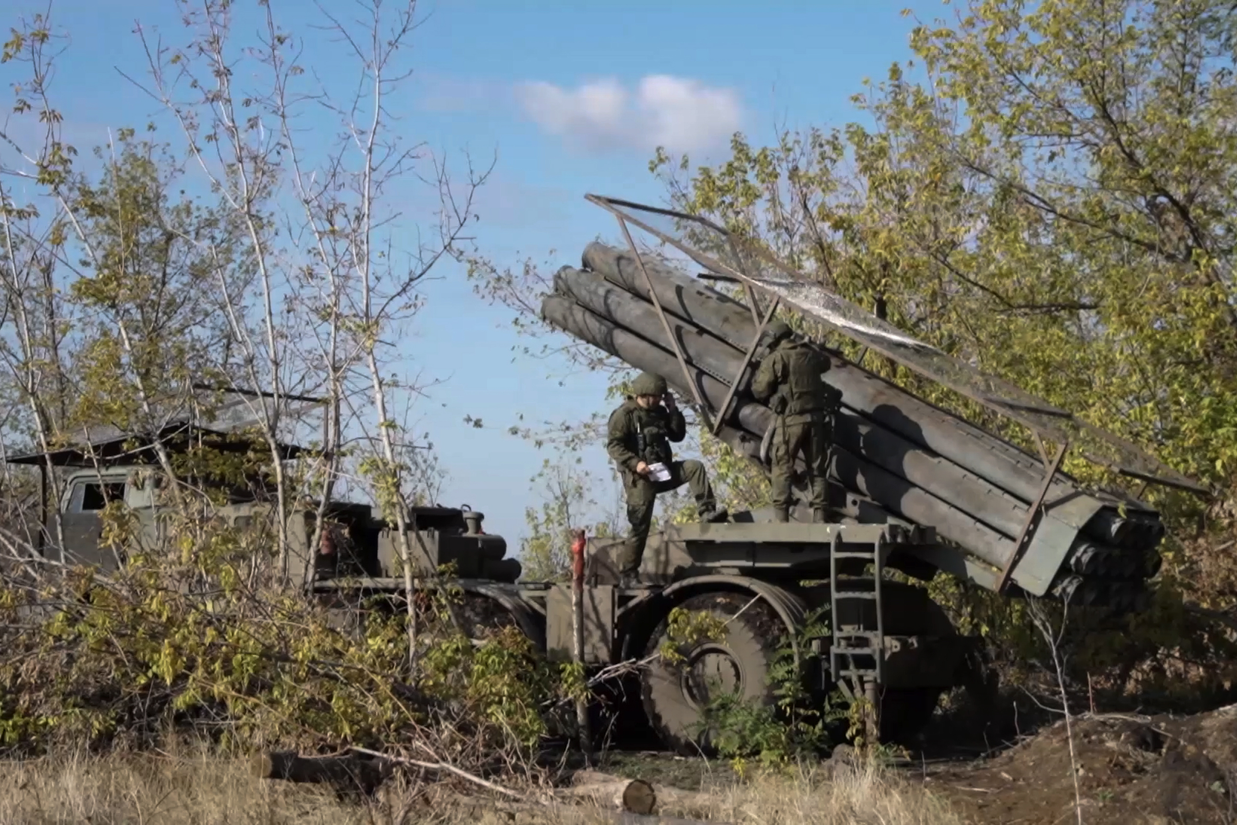 In this photo taken from a video released by Russian Defense Ministry press service on Monday, Nov. 25, 2024, Russian servicemen operate a Russian Uragan self-propelled multiple rocket launcher in an undisclosed location. (Russian Defense Ministry Press Service via AP)