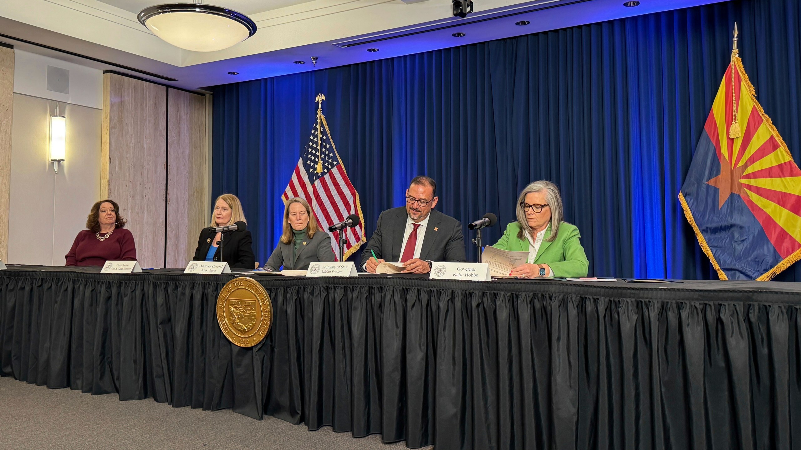 Arizona Gov. Katie Hobbs, right, and Secretary of State Adrian Fontes sign off on election results as state Attorney General Kris Mayes, Arizona Supreme Court Chief Justice Ann Timmer and state election director Lisa Marra look on during the state canvassing meeting in Phoenix, Monday, Nov. 25, 2024. (AP Photo/Gabriel Sandoval)