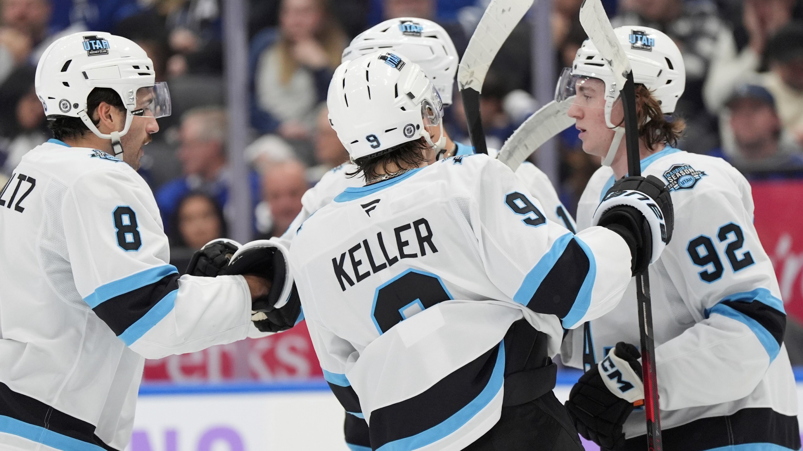 Utah Hockey Club centre Logan Cooley (92) celebrates his goal against the Toronto Maple Leafs with teammates during the first period of an NHL hockey game in Toronto, Sunday, Nov. 24, 2024. (Frank Gunn/The Canadian Press via AP)