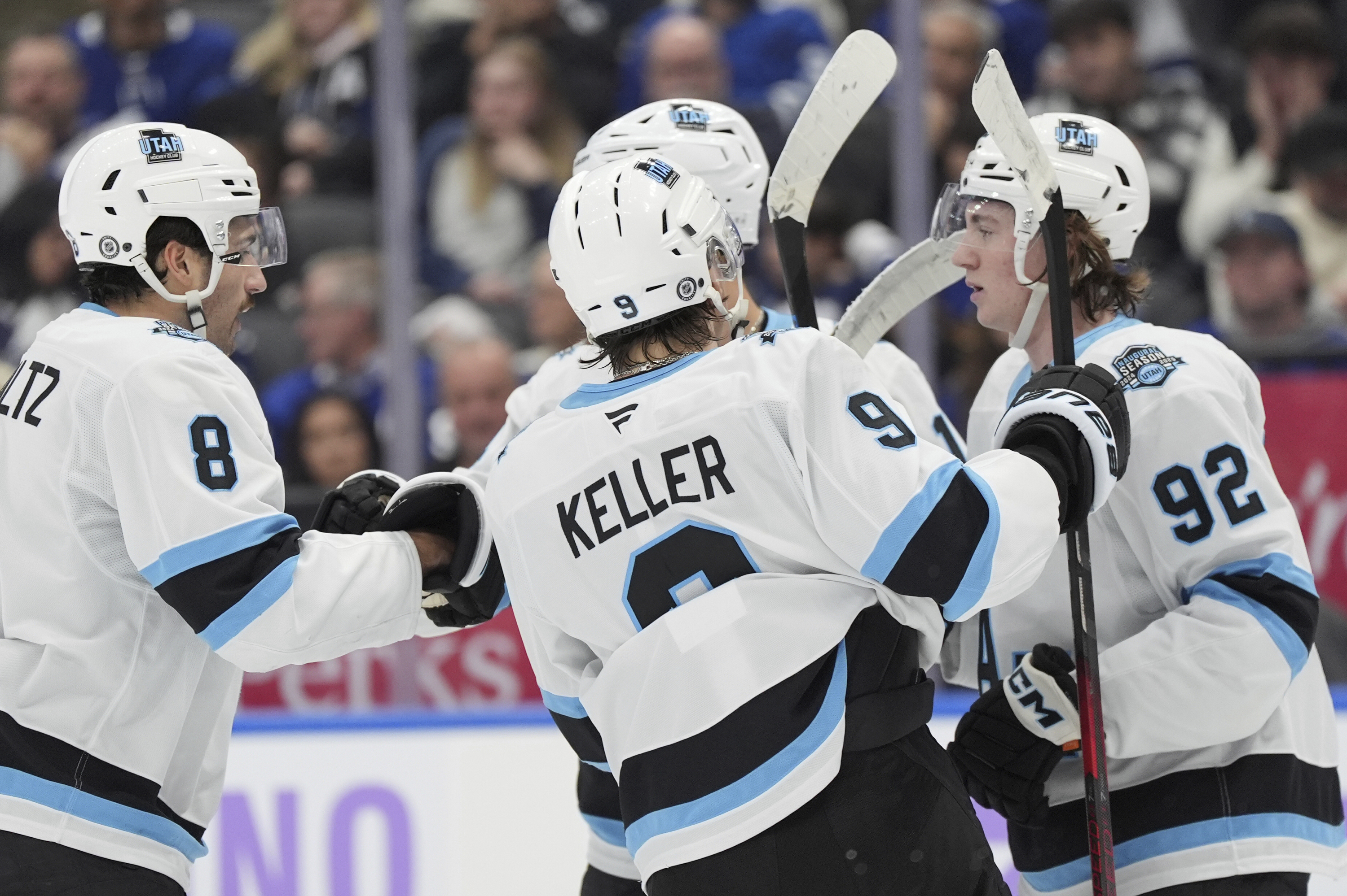 Utah Hockey Club centre Logan Cooley (92) celebrates his goal against the Toronto Maple Leafs with teammates during the first period of an NHL hockey game in Toronto, Sunday, Nov. 24, 2024. (Frank Gunn/The Canadian Press via AP)