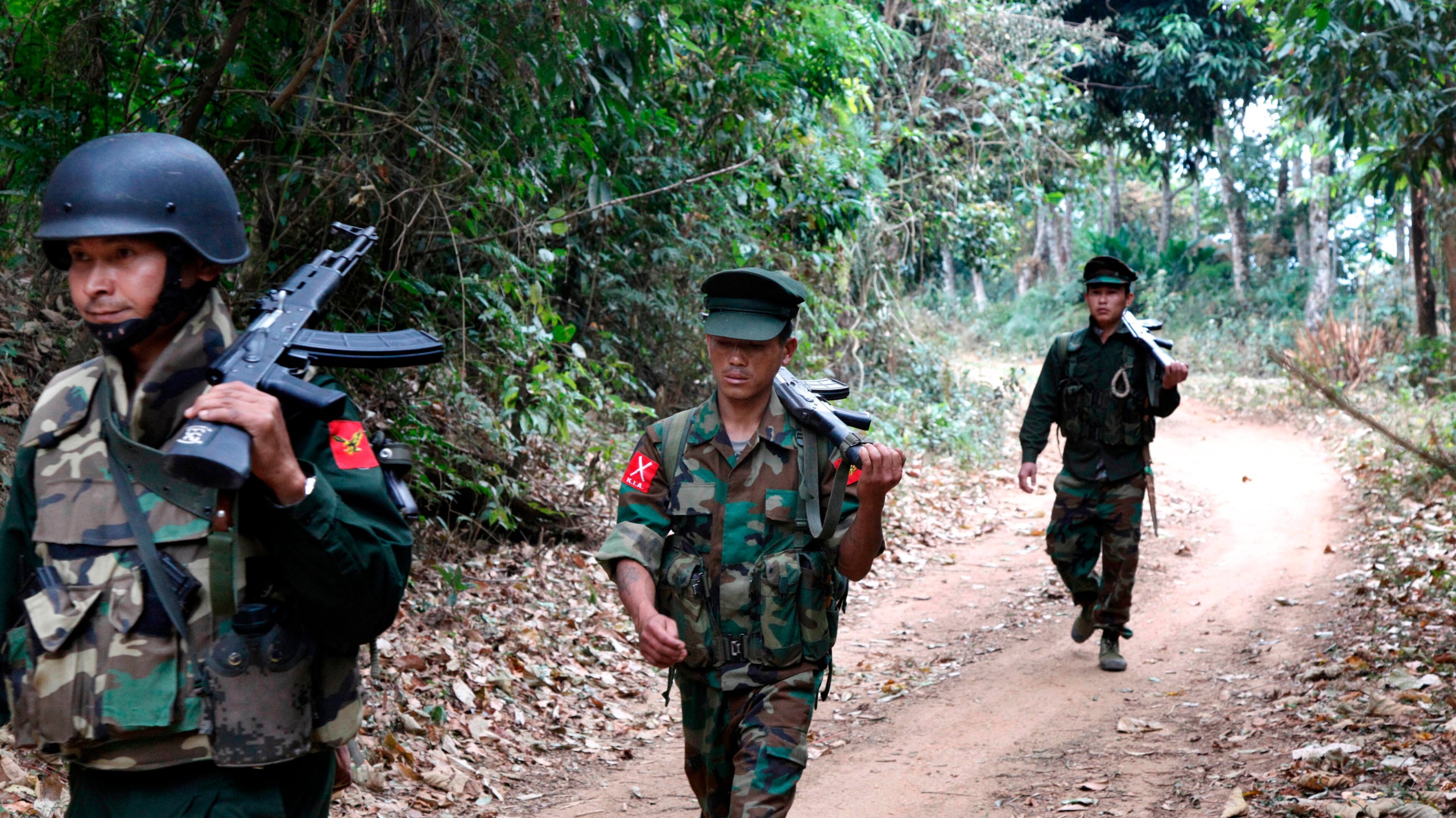 FILE- Kachin Independence Army fighters walk in a jungle path from Mu Du front line to Hpalap outpost in an area controlled by the Kachin rebels in northern Kachin state, Myanmar, March 17, 2018. (AP Photo/Esther Htusan, File)