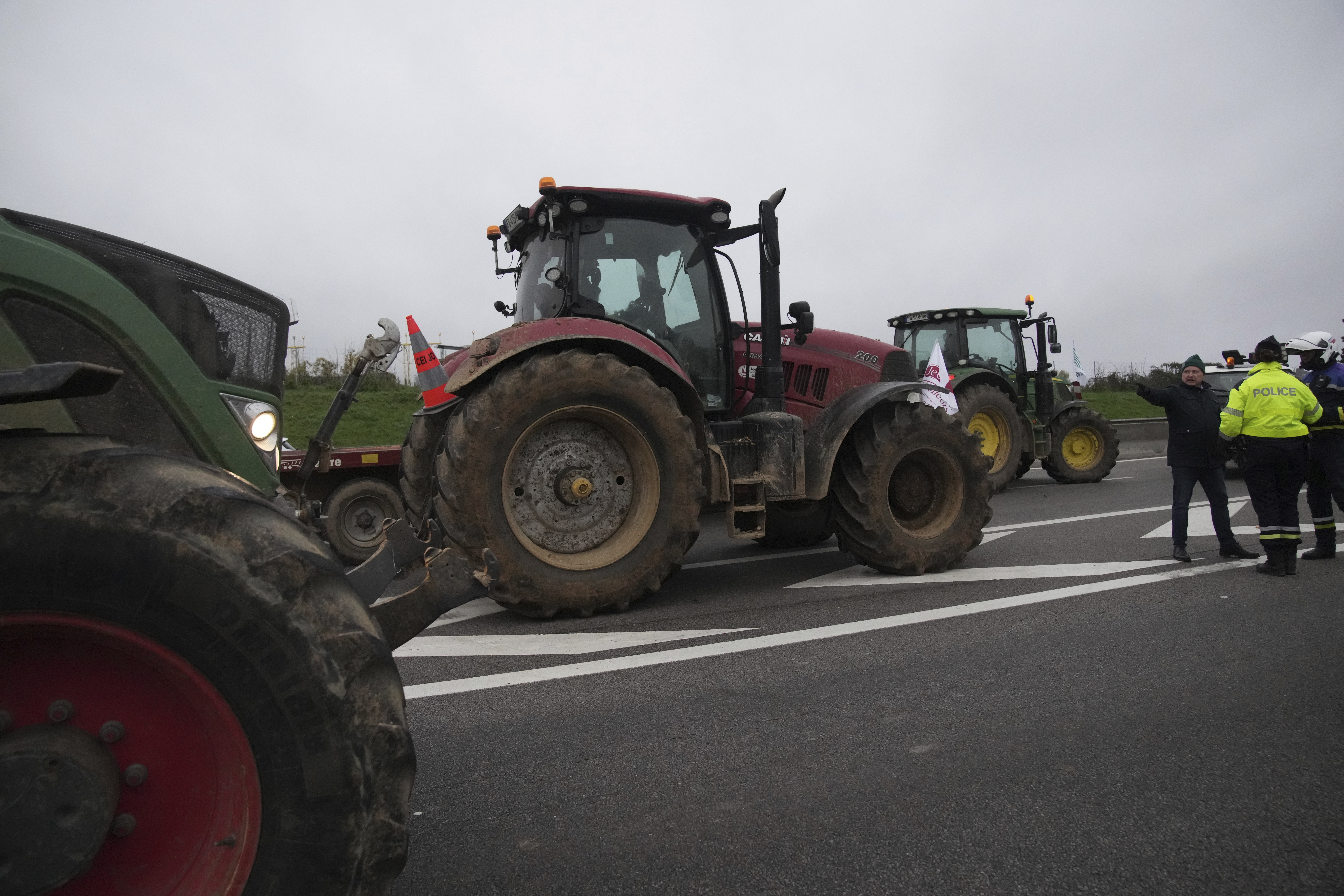 Farmers block a highway to protest the EU-Mercosur trade agreement, Monday, Nov. 18, 2024 in Velizy-Villacoublay outside Paris. (AP Photo/Christophe Ena)