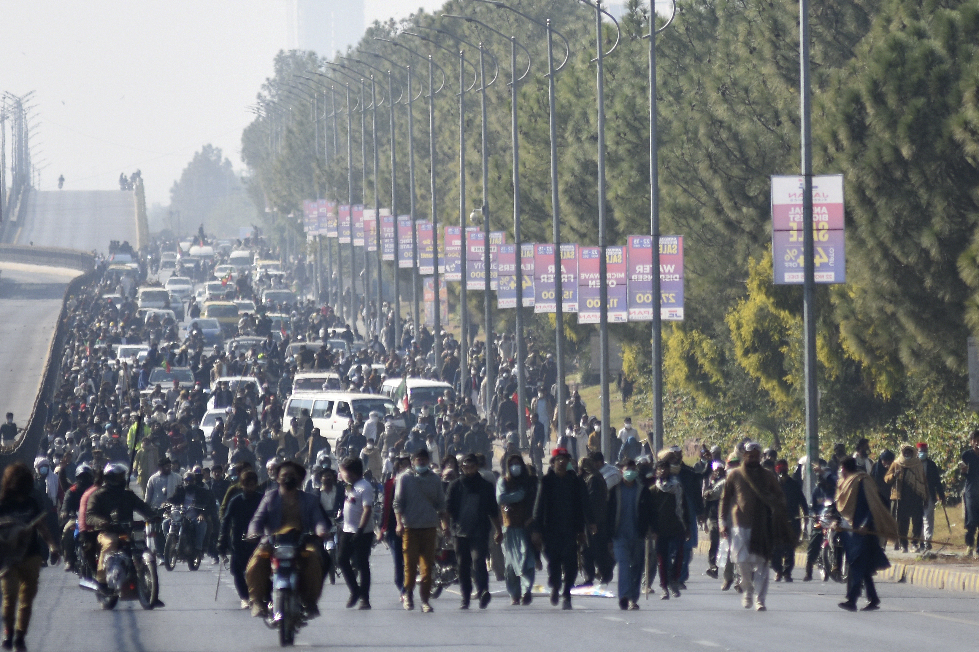 Supporters of imprisoned former premier Imran Khan's Pakistan Tehreek-e-Insaf party move towards D-Chowk square close to Red Zone, which is an area that houses key government buildings, during their rally demanding Khan's release, in Islamabad, Pakistan, Tuesday, Nov. 26, 2024. (AP Photo/W.K. Yousufzai)