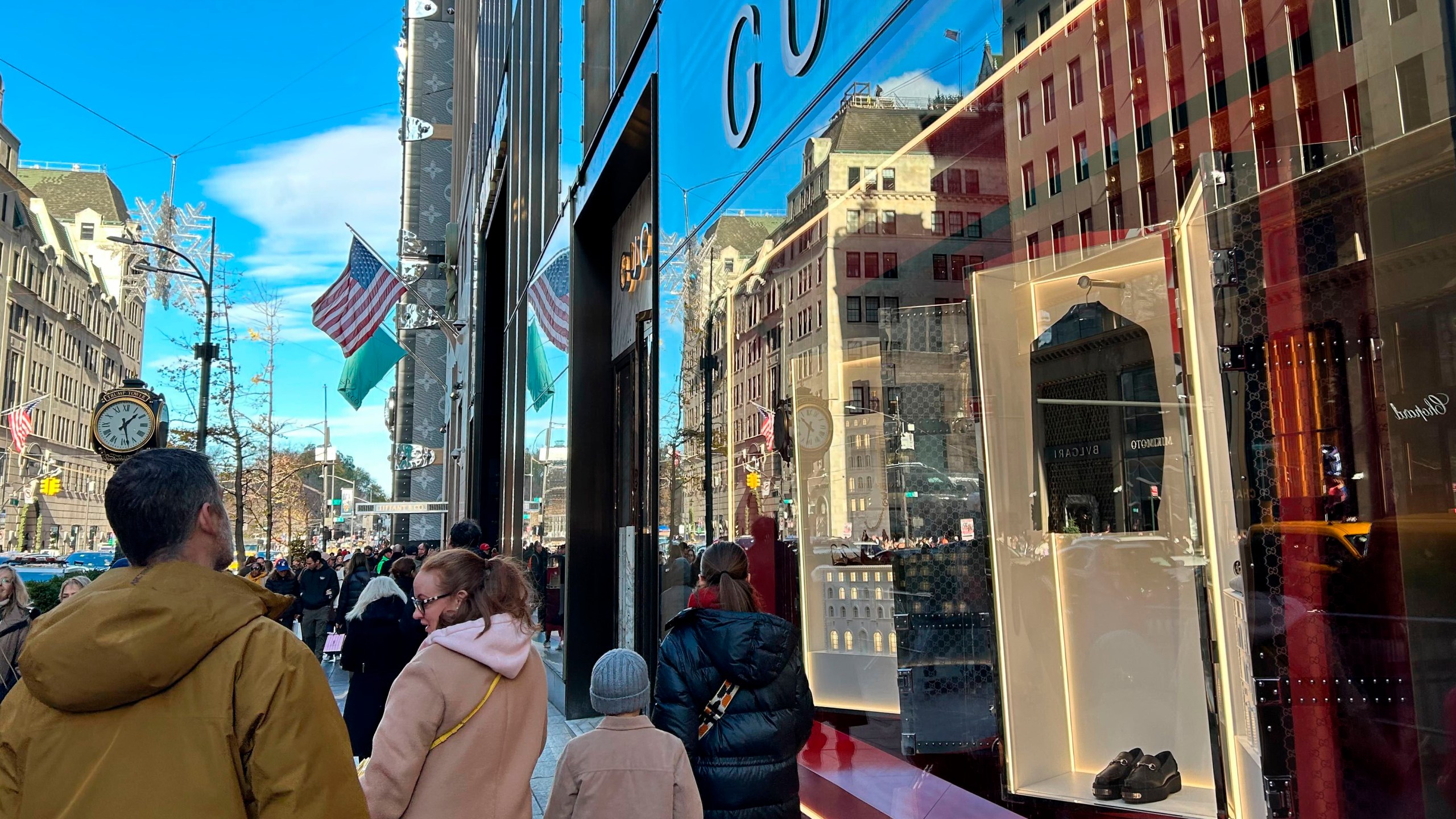 People walk past stores on Fifth Ave. on Sunday, Nov. 24, 2024, in New York. (AP Photo/Anne D'Innocenzio)