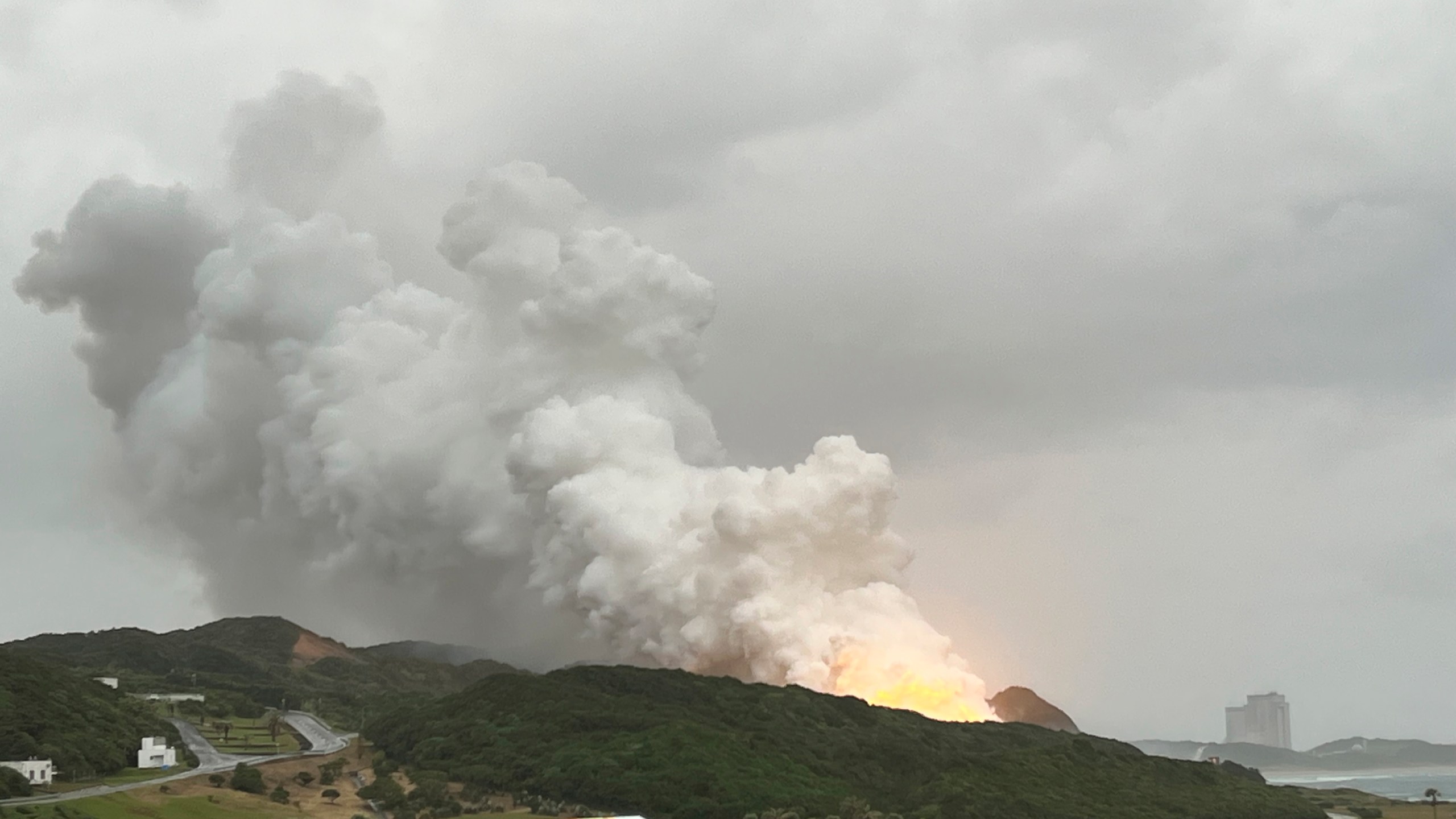 In this photo provided by Japan Aerospace Exploration Agency (JAXA), smoke billows during a combustion test of an engine for new small Japanese rocket Epsilon S at Tanegashima Space Center, in Tanegashima, Kagoshima prefecture, southern Japan, Tuesday, Nov. 26, 2024. (JAXA via AP)