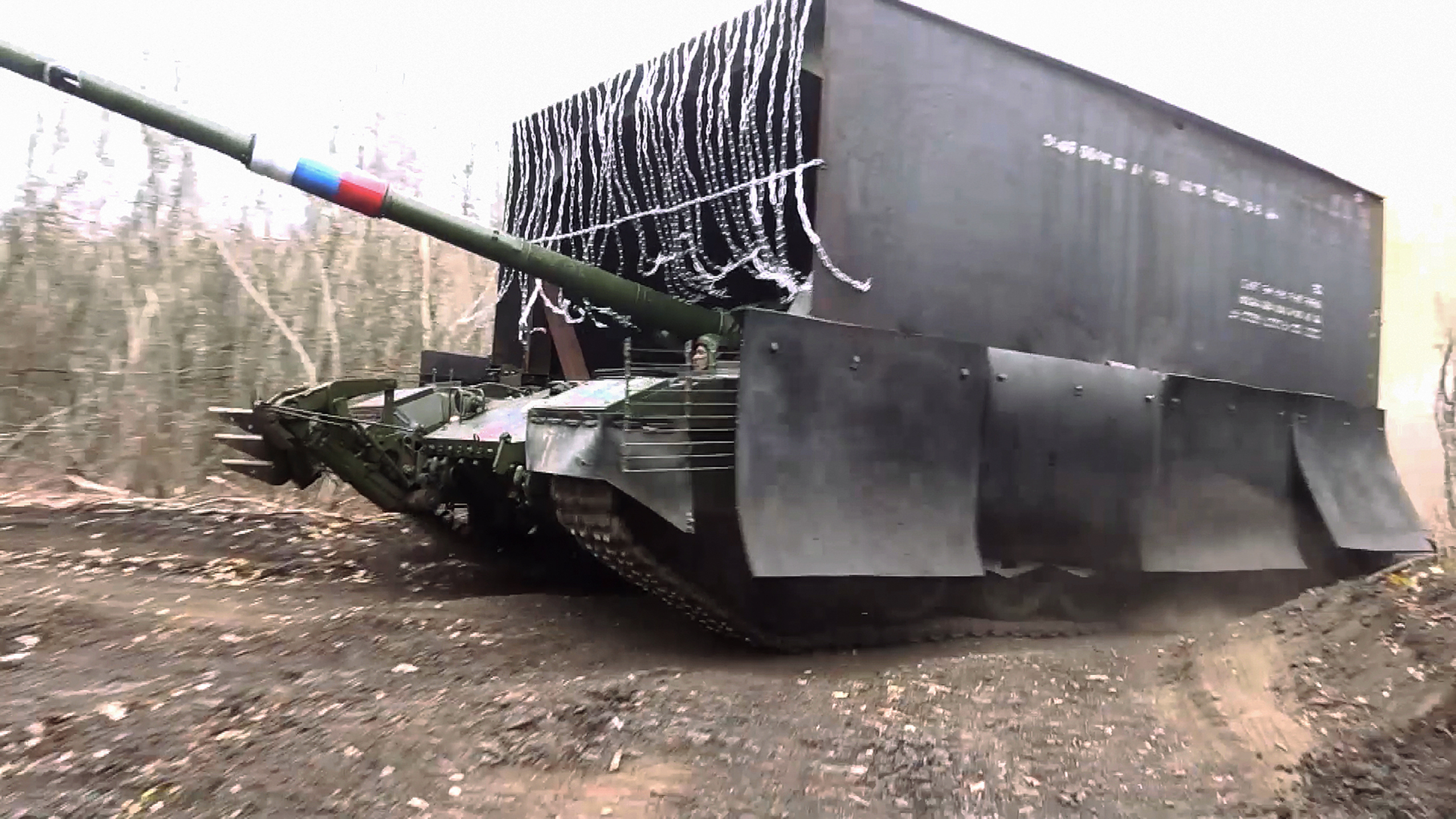 In this photo taken from video released by the Russian Defense Ministry Press Service on Tuesday, Nov. 26, 2024, a Russian T-80 tank rolls in Donetsk region in Ukraine. (Russian Defense Ministry Press Service via AP)