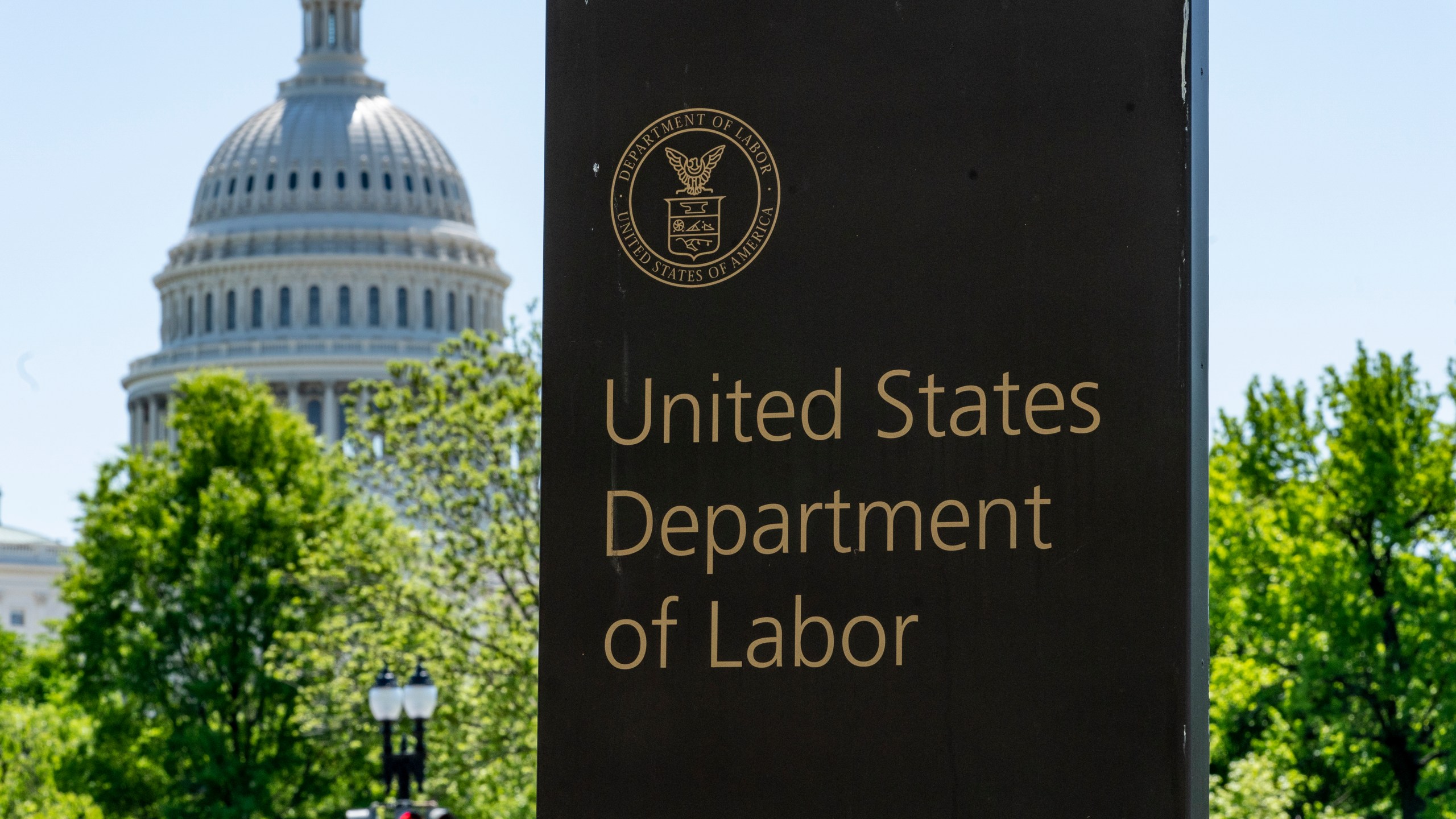 FILE - In this May 7, 2020, photo, the entrance to the Labor Department is seen near the Capitol in Washington. s a nation ravaged by the coronavirus pandemic, the economic devastation upending the presidential campaign and forcing President Donald Trump to overcome historic headwinds to win a second term. (AP Photo/J. Scott Applewhite, File)