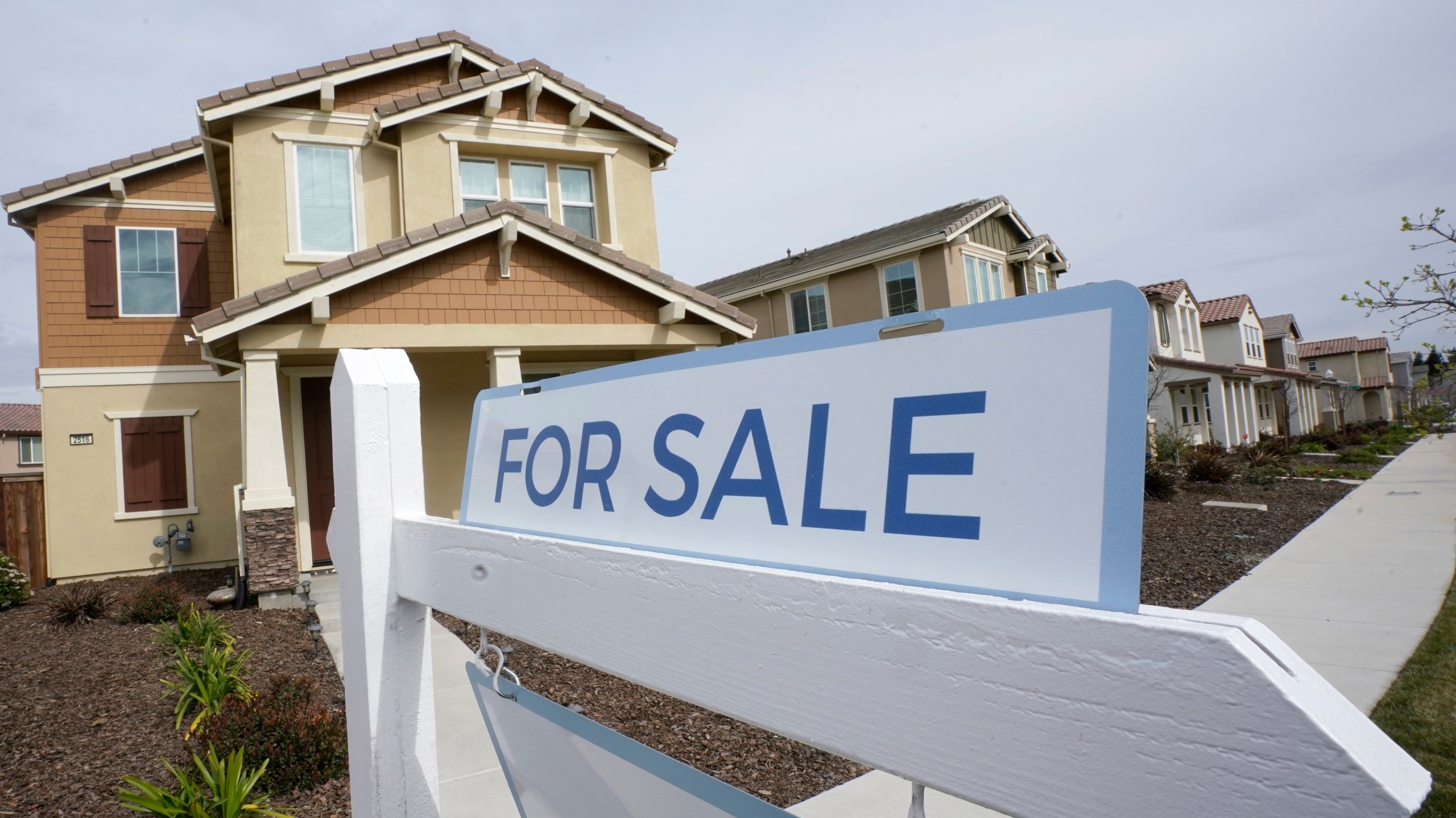 FILE - A for sale sign is posted in front of a home in Sacramento, Calif., March 3, 2022. (AP Photo/Rich Pedroncelli, File)