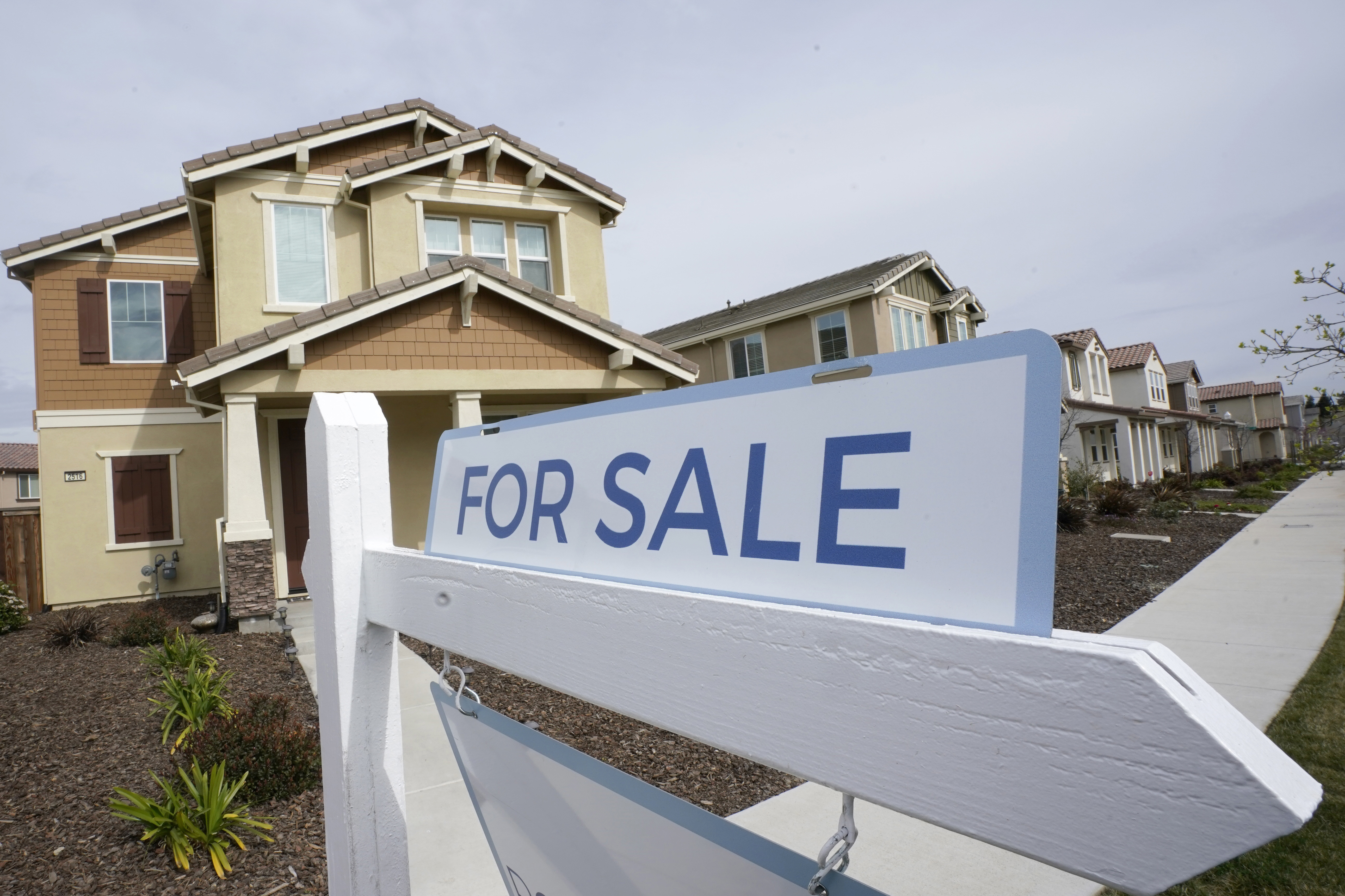 FILE - A for sale sign is posted in front of a home in Sacramento, Calif., March 3, 2022. (AP Photo/Rich Pedroncelli, File)