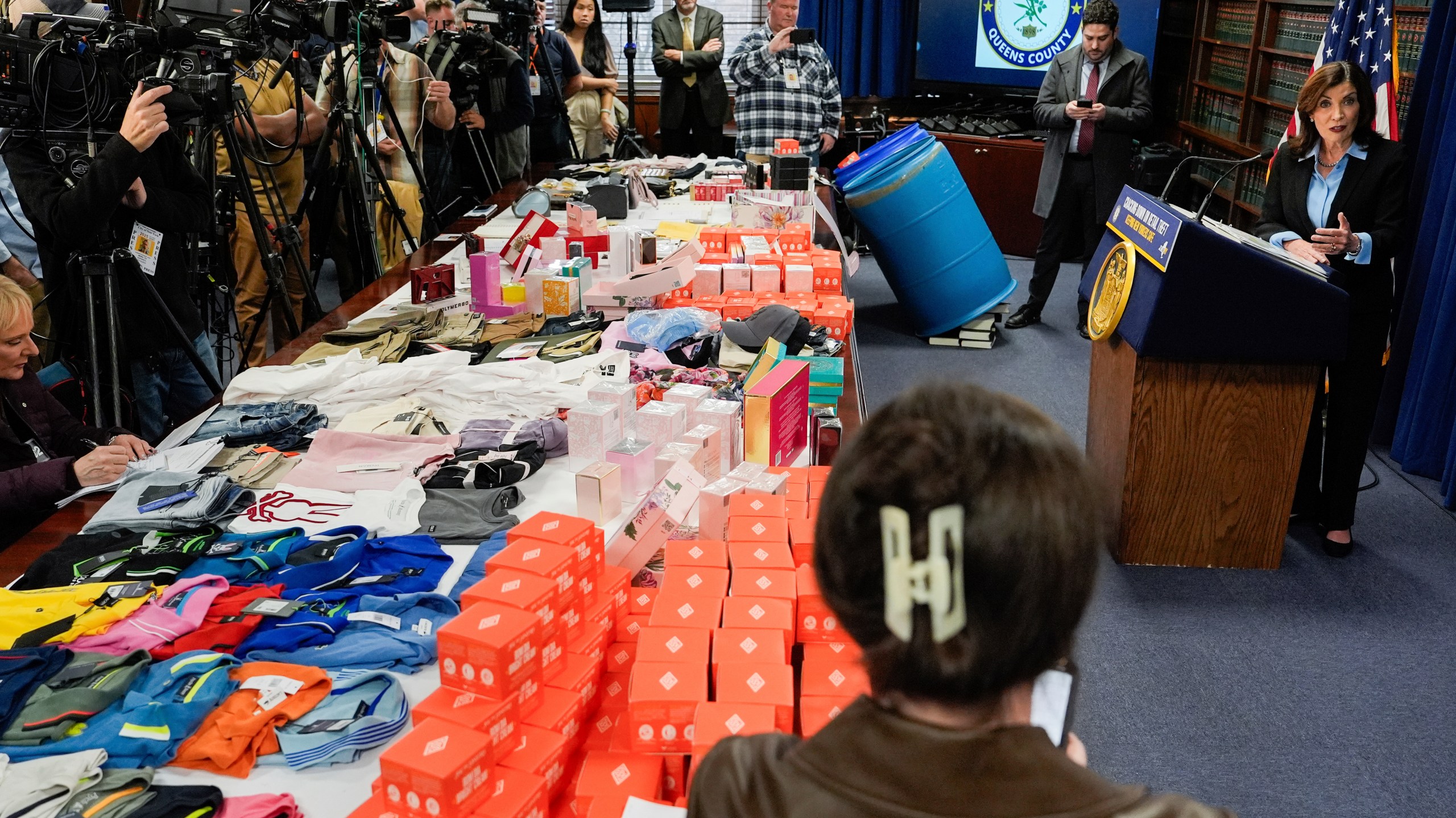 Stolen merchandise is displayed as New York Gov. Kathy Hochul speaks at a press conference on an international stolen merchandise ring, Tuesday, Nov. 26, 2024, in the Queens borough of New York. (AP Photo/Julia Demaree Nikhinson)