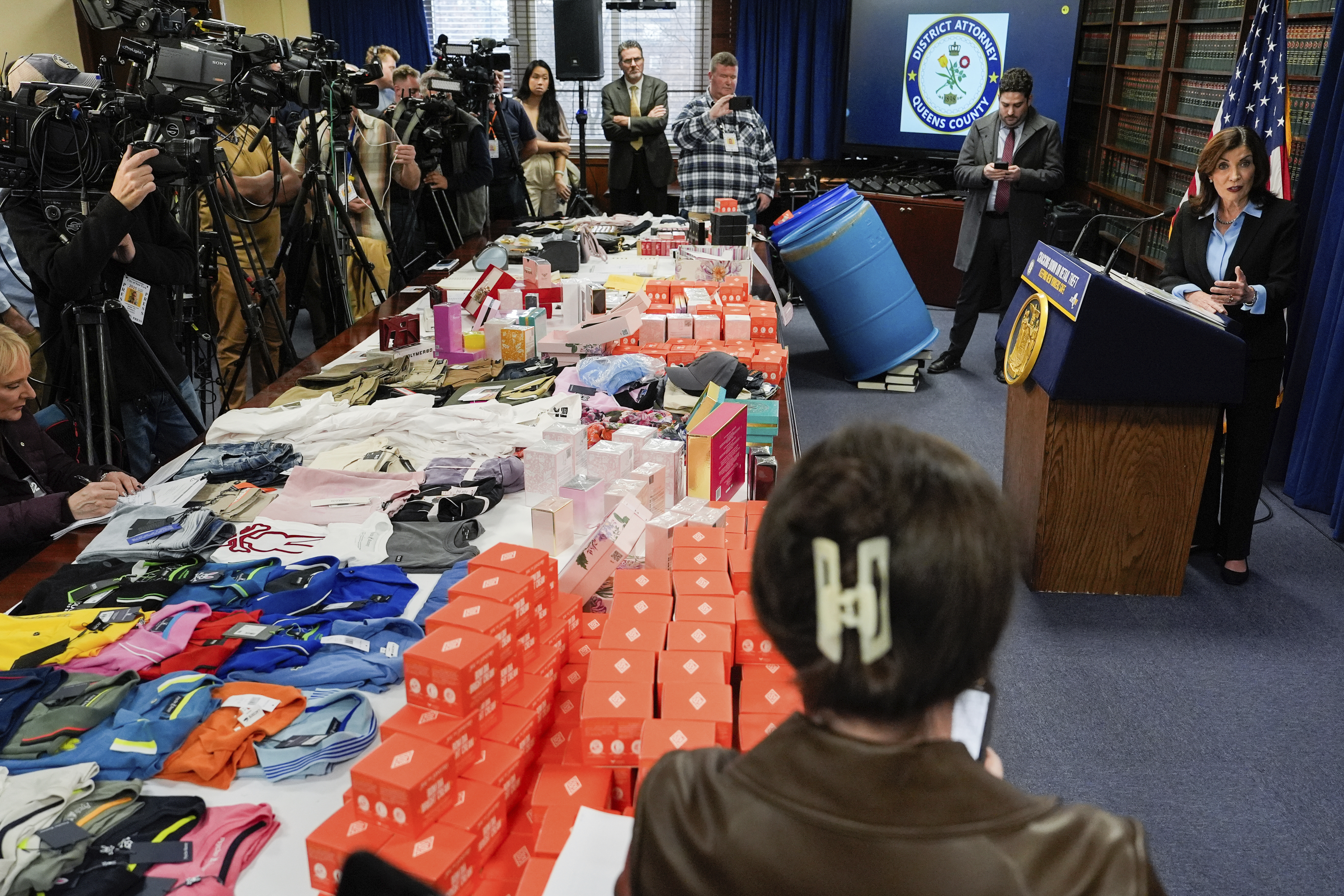 Stolen merchandise is displayed as New York Gov. Kathy Hochul speaks at a press conference on an international stolen merchandise ring, Tuesday, Nov. 26, 2024, in the Queens borough of New York. (AP Photo/Julia Demaree Nikhinson)