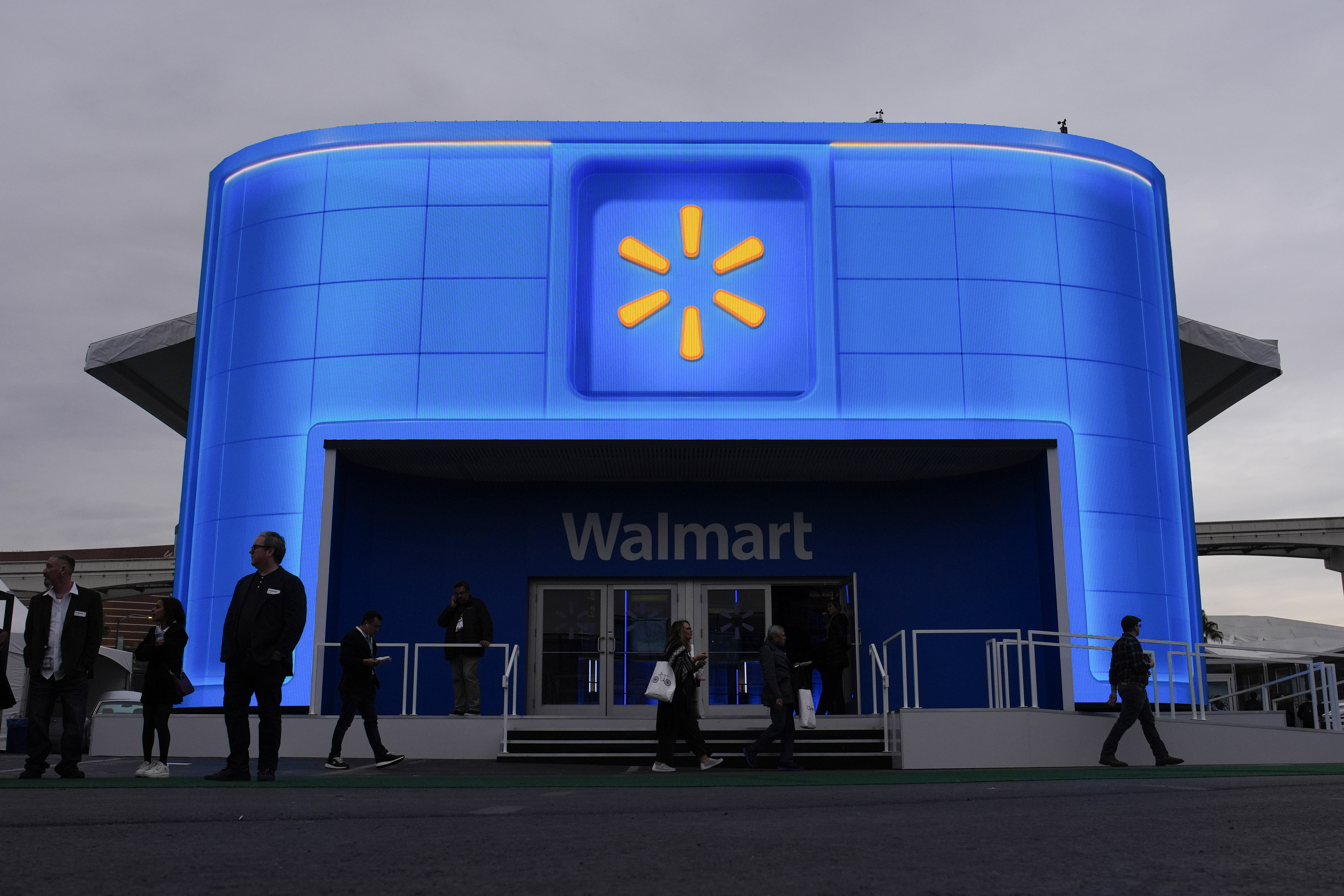 FILE - People walk by the Walmart booth during the CES tech show on Jan. 9, 2024, in Las Vegas. (AP Photo/John Locher, File)