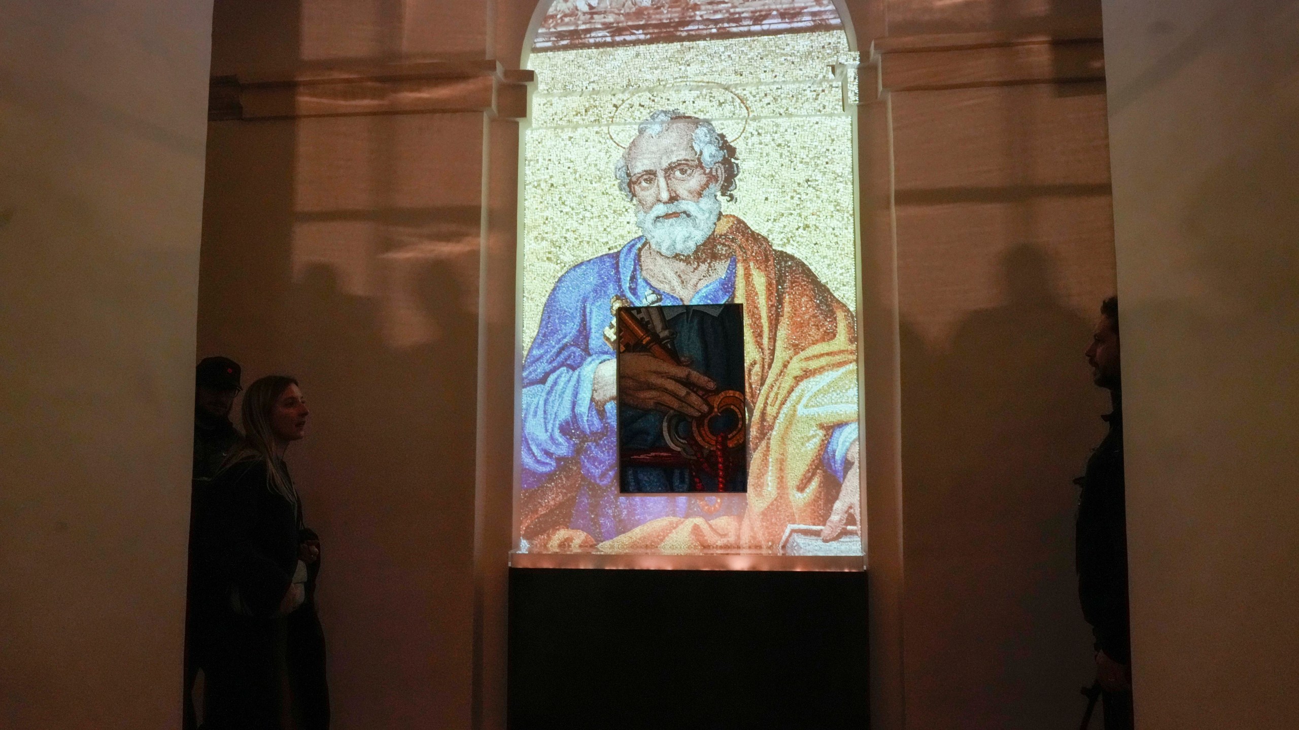 An image of St. Peter is projected on a screen during the preview to the press of the exhibition 'Petros eni', which is part of the project "St. Peter's Basilica: AI-Enhanced Experience" at the Vatican, Saturday, Nov. 9, 2024. (AP Photo/Gregorio Borgia)