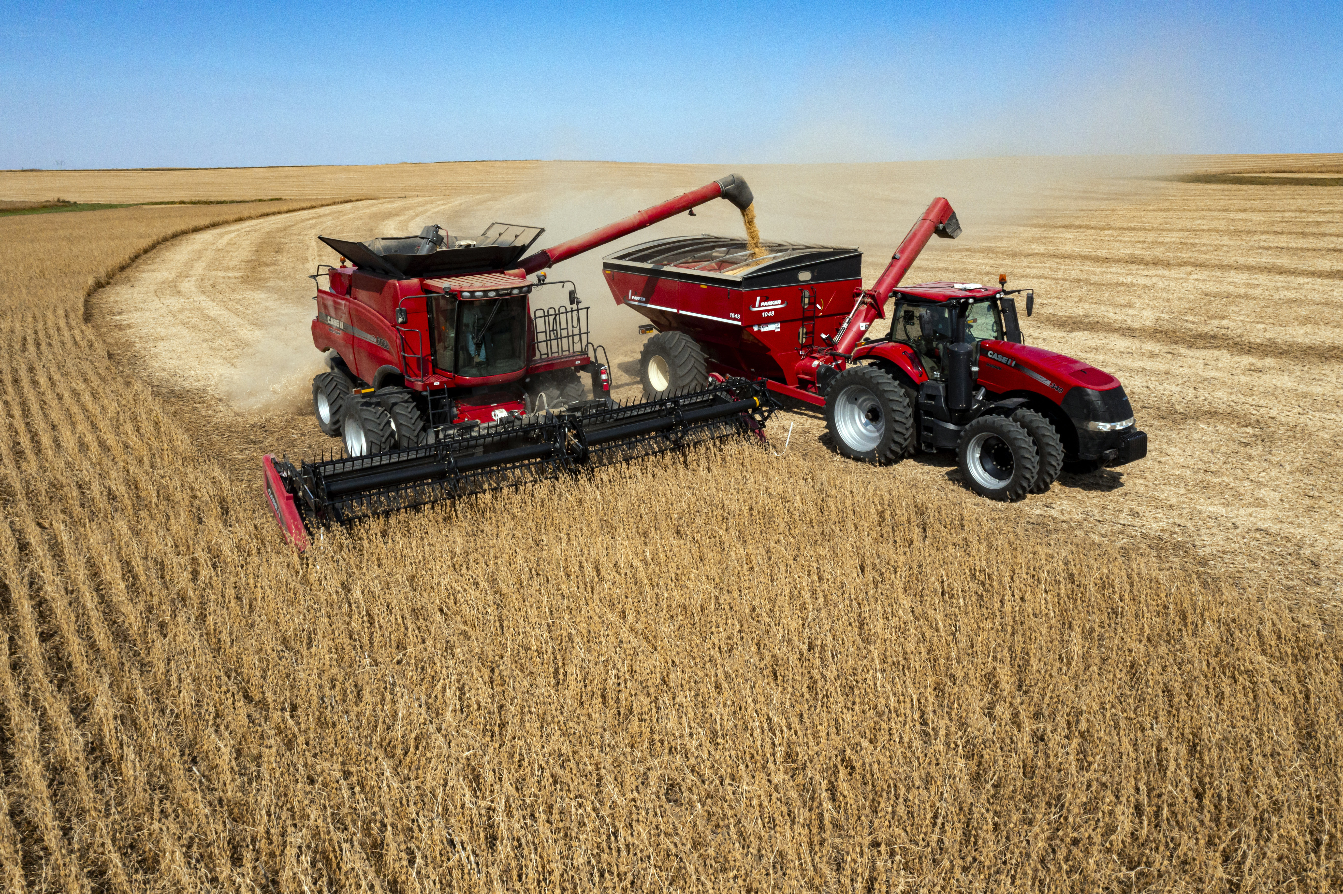 FILE - In this image taken with a drone, Jason Kwapi operates a combine, at left, during soybean harvesting on the Voss farm near Palo, Iowa, Oct. 2, 2024. (Nick Rohlman/The Gazette via AP, File)