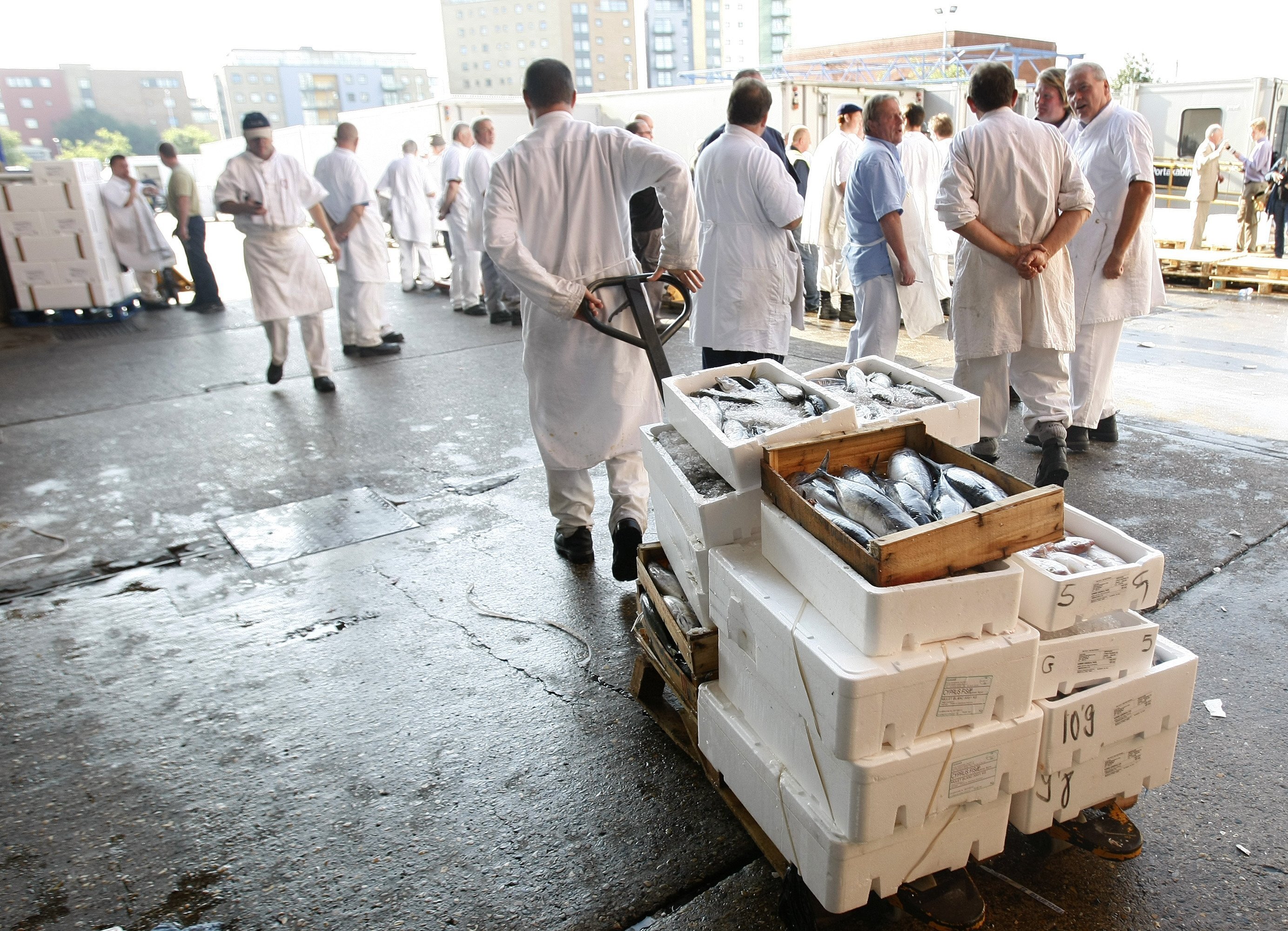 FILE - Traditional porters at work at Billingsgate fish market in London, on Aug. 3, 2010. (AP Photo/Alastair Grant, File)