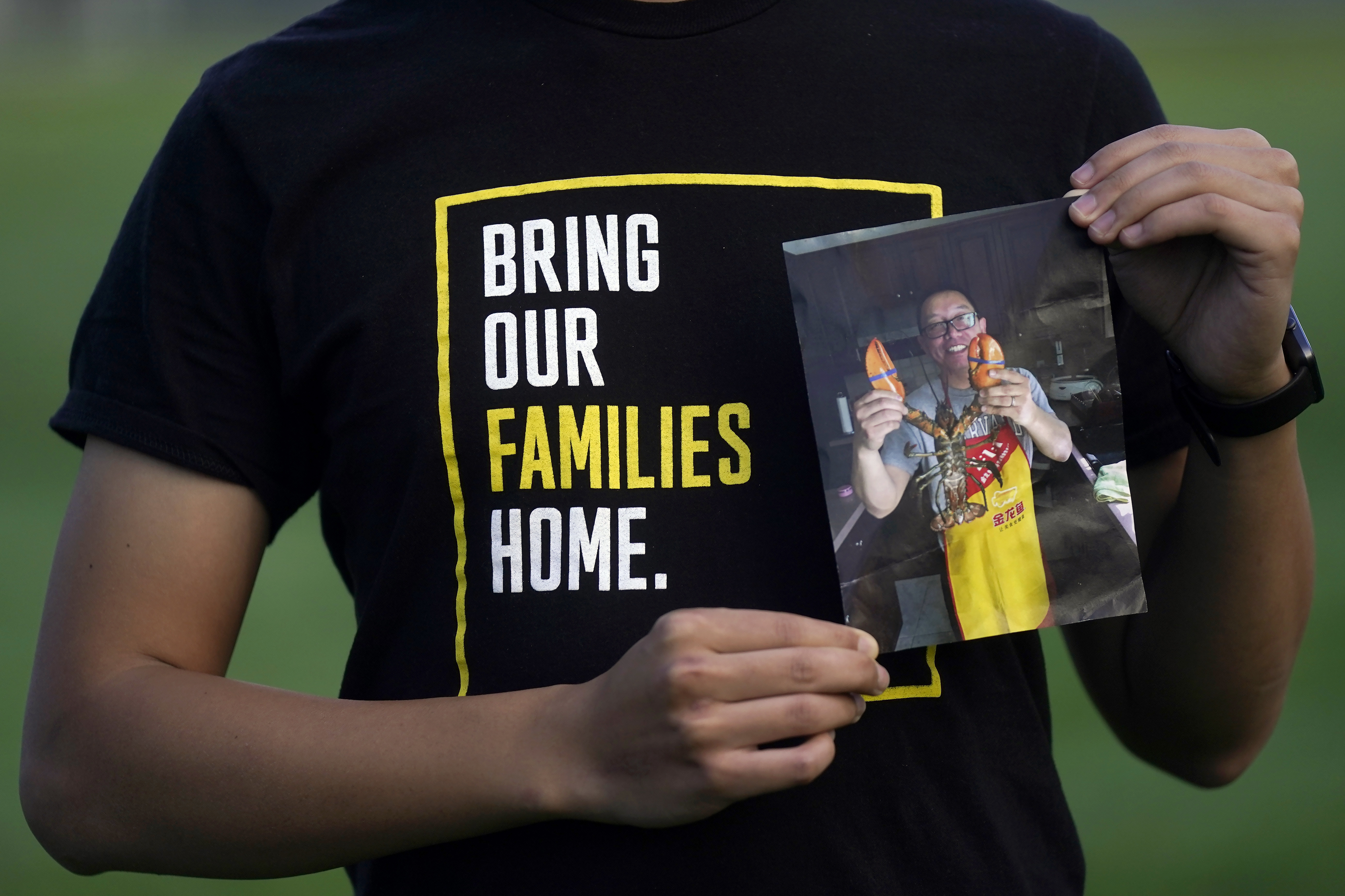 FILE - Harrison Li holds a photo of his father, Kai Li, as he poses for a photo, Tuesday, Jan. 23, 2024, in Palo Alto, Calif. (AP Photo/Jeff Chiu)