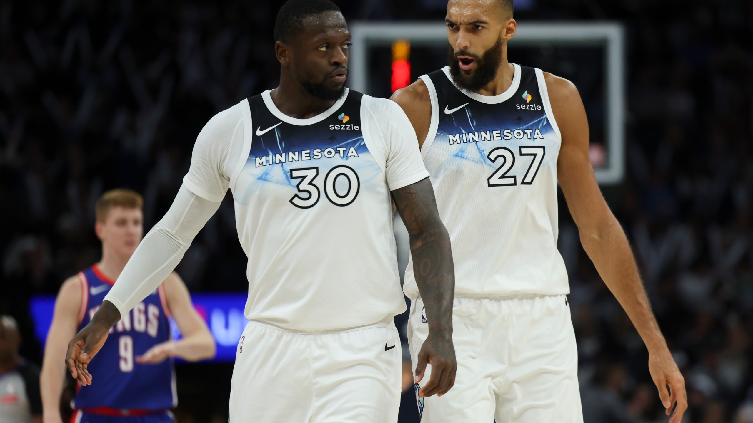 Minnesota Timberwolves forward Julius Randle (30) and center Rudy Gobert (27) react during the second half of an NBA basketball game against the Sacramento Kings, Wednesday, Nov. 27, 2024, in Minneapolis. (AP Photo/Ellen Schmidt)