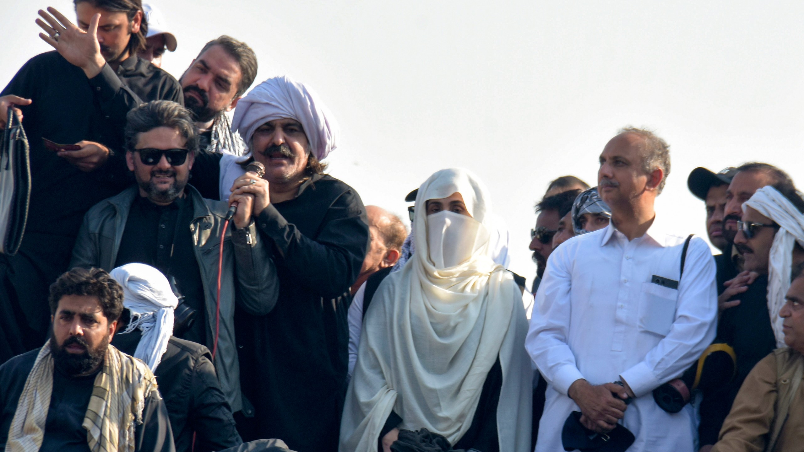 Bushra Bibi, center, wife of imprisoned former premier Imran Khan and leaders of Khan's party lead their supporters during a rally demanding Khan's release, in Islamabad, Pakistan, Tuesday, Nov. 26, 2024. (AP Photo/W.K. Yousufzai)