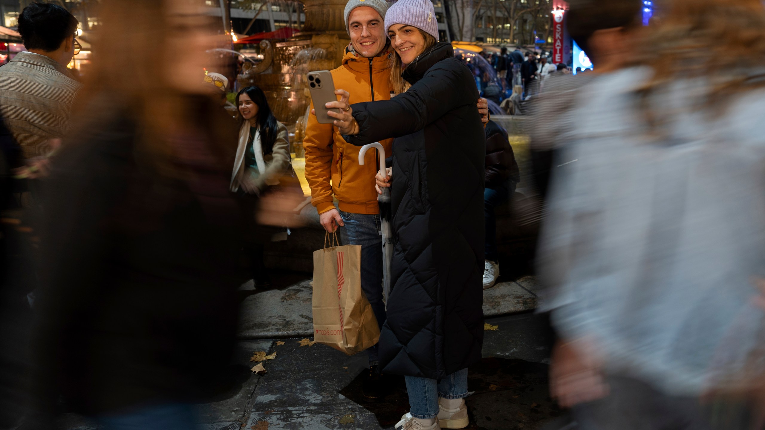 People take a selfie in Bryant Park's Winter Village, Tuesday, Nov. 26, 2024, New York. (AP Photo/Julia Demaree Nikhinson)