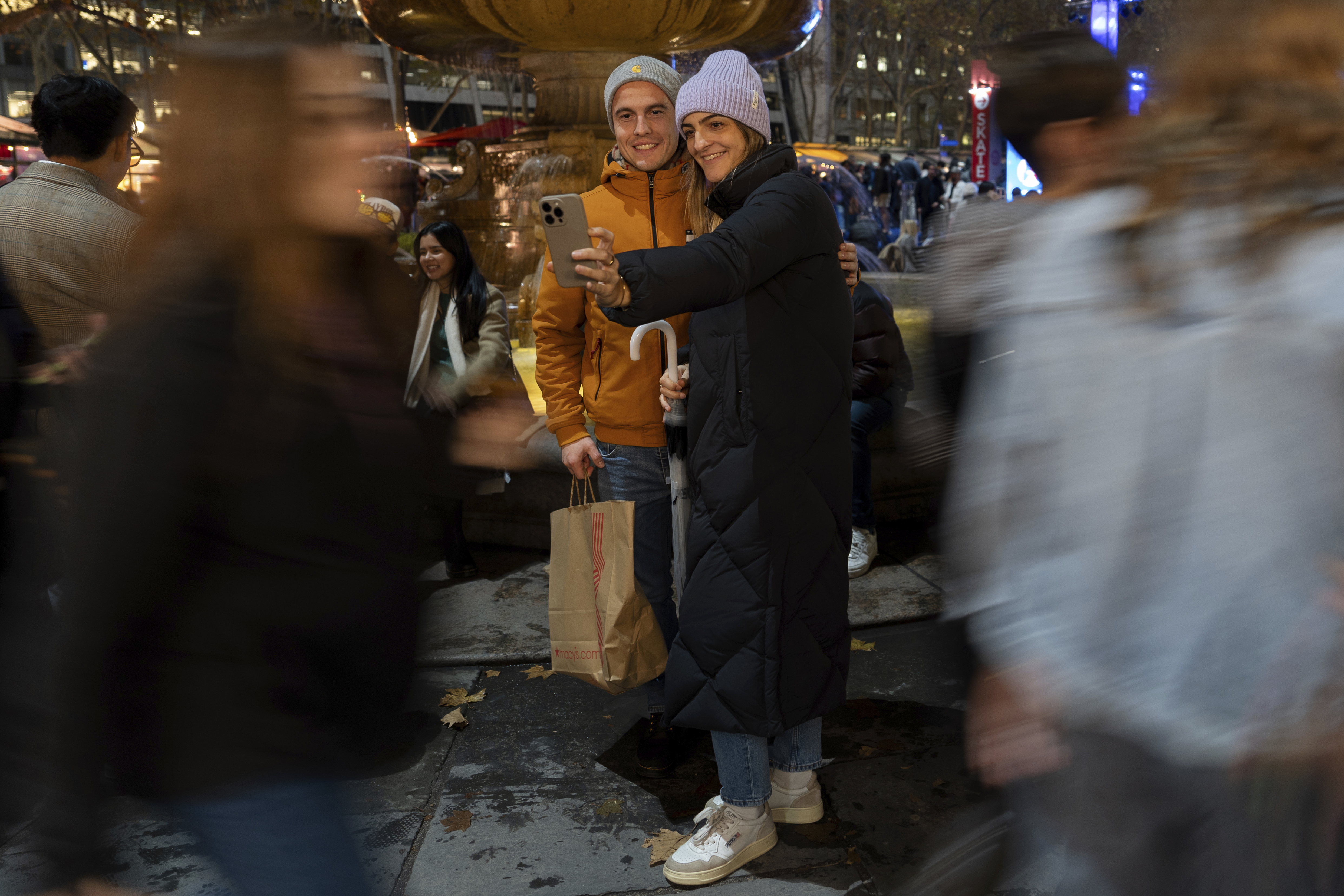 People take a selfie in Bryant Park's Winter Village, Tuesday, Nov. 26, 2024, New York. (AP Photo/Julia Demaree Nikhinson)