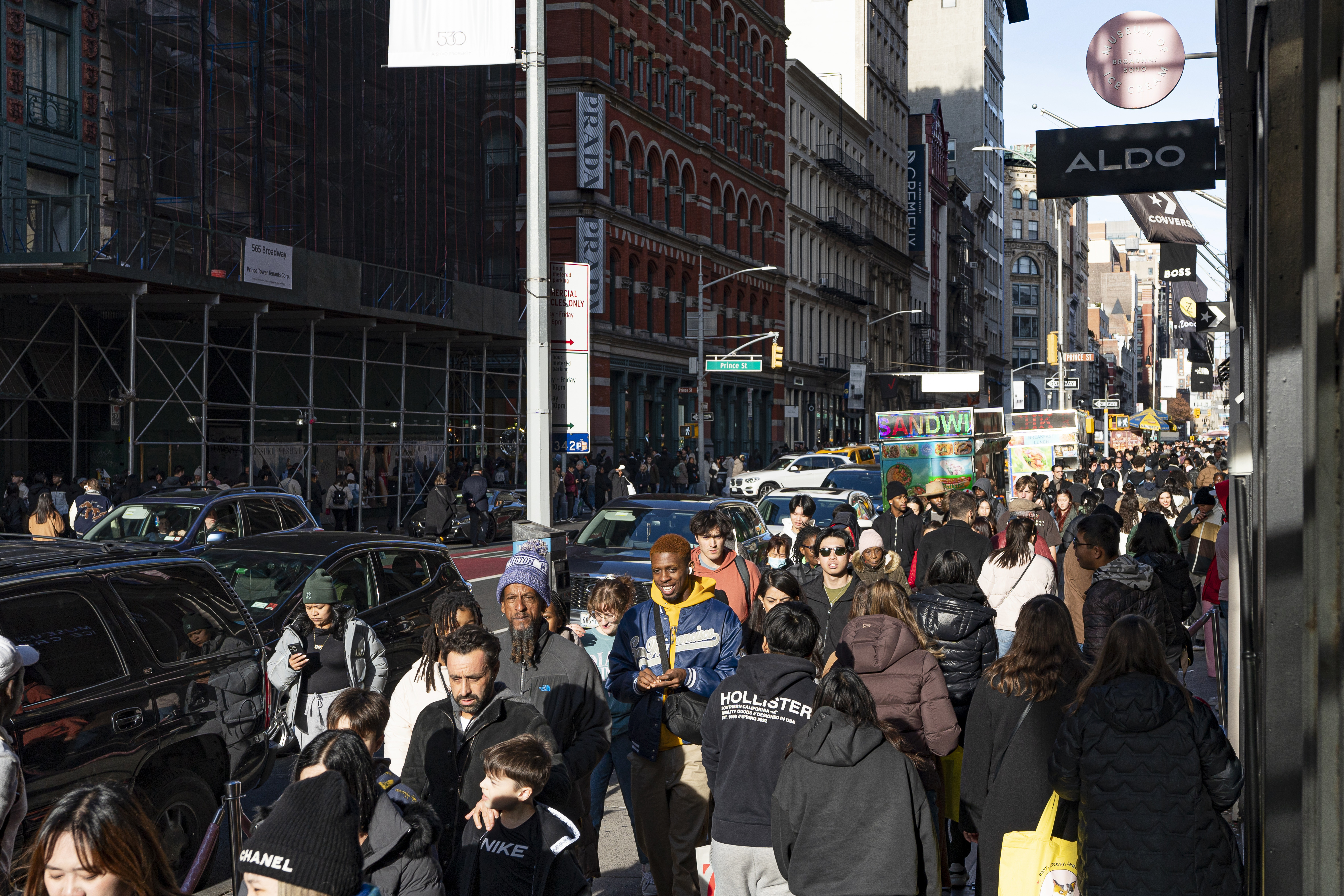 FILE - Shoppers and others walk down a crowded sidewalk on Black Friday in the Soho neighborhood of New York, Nov. 24, 2023. (AP Photo/Peter K. Afriyie, File)